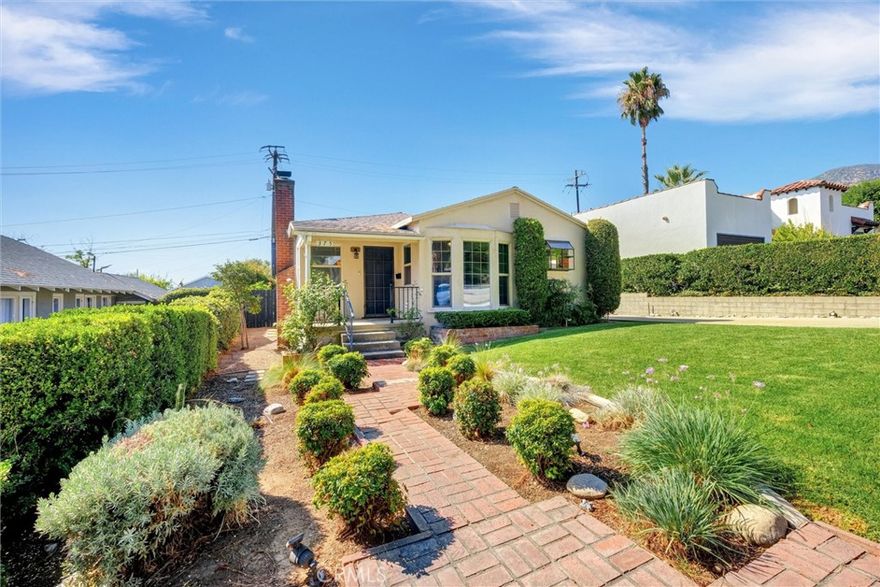 Discover this North Monrovia gem where mid-century charm meets modern comfort. Located on a beautiful tree-lined street in North Monrovia, just minutes from the newly reopened Canyon Park, this traditional home has been lovingly cared for by only two owners since 1947. If you’ve been searching for a Monrovia home for sale with timeless character, this is the one that feels like “home” the moment you arrive. Step inside from the inviting front porch to a bright, spacious living room filled with natural light. Original hardwood floors, a classic brick fireplace, and large picture windows make this space both warm and welcoming. The adjacent dining area features a sunny bay window, and the remodeled kitchen offers the perfect blend of old and new, with custom wood cabinetry, stainless steel appliances, a garden window, recessed lighting, and a stylish tile backsplash. 
The primary suite is a peaceful retreat, complete with chevron wood floors, built-in storage, and French doors that open to a large backyard - ideal for relaxing, gardening, or entertaining. The two additional bedrooms share a full bath that celebrates the home’s vintage roots with its original ceramic tile and cast-iron tub.  Additional highlights include central air and heat, dual-pane windows, upgraded electrical, ceiling fans, laundry hookups, and a two-car detached garage. This is North Monrovia living at its best - close to hiking trails, nature, and just a short drive from Old Town Monrovia’s shops, restaurants, and community events. A rare opportunity to own a home with history, heart, and all the right updates for modern life. 
(Some mages have been virtually staged.)