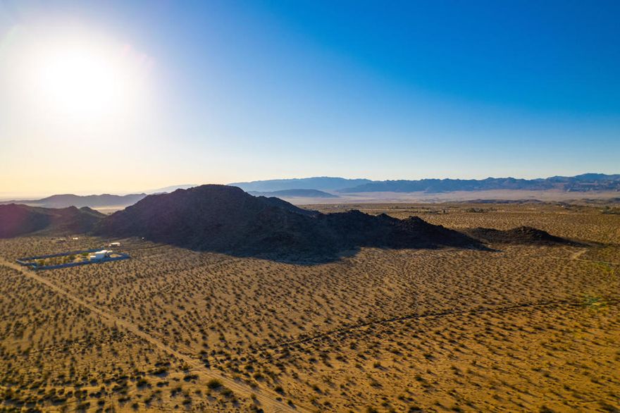 Welcome to 63280 Starlight Street, a unique development opportunity nestled in the heart of Joshua Tree, CA. This expansive 38.95 acre lot offers a rare canvas for visionary builders and investors. Imagine the potential of crafting up to seven bespoke homes, each harmoniously integrated into the stunning desert landscape.This property is a stone's throw away from some of the region's most architecturally significant builds, making it a prime location for those looking to create something extraordinary. The lot features striking natural boulders, adding an authentic touch of rugged beauty that is quintessentially Joshua Tree. These natural formations provide a unique backdrop and inspire endless design possibilities.Conveniently located near paved road access, this property offers both seclusion and accessibility, allowing future residents to enjoy the tranquility of the desert while being just minutes away from essential amenities. The surrounding area is renowned for its vibrant arts scene, outdoor adventures, and the iconic Joshua Tree National Park, providing a rich lifestyle for potential homeowners.Whether you're envisioning a private desert retreat or a collection of architecturally stunning homes, 63280 Starlight Street offers the perfect blend of opportunity and inspiration. Embrace the chance to create something truly remarkable in one of Southern California's most captivating locales.