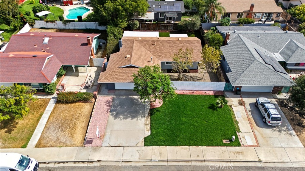 Welcome to this charming, centrally located home just minutes from the 91 freeway, dining, and entertainment! This well-maintained property truly reflects pride of ownership. Enjoy the privacy of a gated entrance-no more interruptions from door-to-door solicitors. Inside, you’ll find an open-concept layout filled with natural light, thanks to windows surrounding the living room and kitchen. The spacious living area flows effortlessly into the dining space, making it perfect for entertaining or everyday comfort. The overside 2 car garage is located right off the living room. It features built in cabinets and a laundry area. This home offers three bedrooms, including a generously sized primary suite with private access to the backyard, where mature fruit trees provide a peaceful outdoor retreat. The property has been fully remodeled from newer HVAC system, bathrooms, kitchen, stucco, recessed lighting, flooring, windows & water heater.