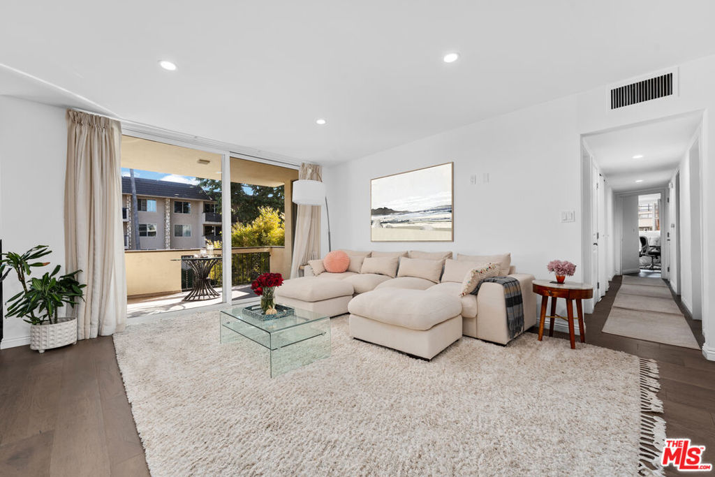 Sunlight pours into this spectacular, fully remodeled 3 bedroom, 3 bath condo in the heart of Brentwood. Rare for the area, this single level unit offers nearly 1,700 square feet of stylish living with an open layout that feels bright and inviting. A formal entry leads into the main living and dining areas, with wide plank light wood floors, recessed lighting, and a gas fireplace with elegant marble surround. Floor to ceiling sliding doors and walls of glass open to three generous balconies, creating great indoor outdoor flow and leafy treetop views down Montana Avenue. The redesigned kitchen features crisp white quartz countertops, modern cabinetry, and stainless steel appliances perfect for the home chef and entertaining. Each of the three bedrooms has its own updated bath, offering comfort and privacy throughout. The primary suite stands out with a walk in closet and ensuite bath. Set in Villa Montana, a mid century building designed by architect Jack Chernoff, AIA, the property includes access to resort style amenities like a heated pool, dry sauna, and a well equipped gym. Includes two tandem parking spaces in a secure garage and private storage. HOA dues cover water, gas, and earthquake insurance. Unbeatable location across from the Sunday farmers market and moments from top rated schools, parks, and the best shops and restaurants along San Vicente and Montana. A rare turnkey offering in one of West LA's most desirable neighborhoods.