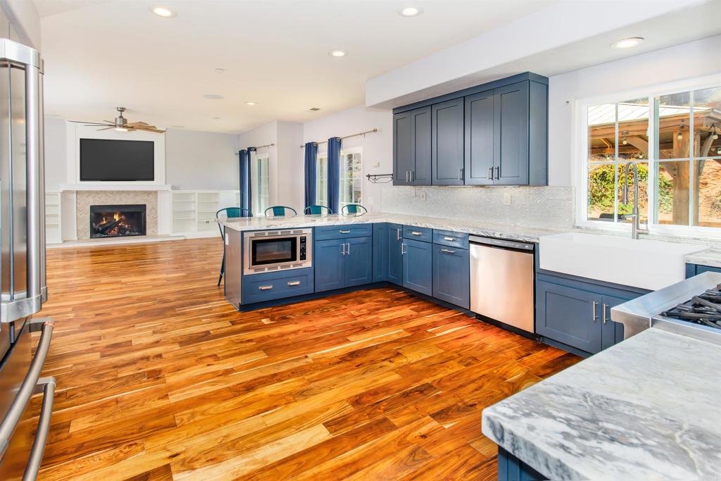 Spacious and stylish in San Diego Country Estates! This 4-bedroom, 3-bath home offers over 2,800 sq. ft. on a half-acre lot with plenty of upgrades to love. Inside, you’ll find beautiful Acacia flooring and a fully remodeled chef’s kitchen featuring a Bluestar range, Café French door refrigerator, built-in microwave, and solid stone counters. The family room is set up for fun with flush-mount Monoprice speakers, HDMI in-wall wiring, and 5.1 surround sound—perfect for movie nights or gaming. Enjoy the benefits of owned solar with Ecoflow Delta Ultra expandable battery backup, a hardwired L2 Tesla EV charger, and a brand-new HVAC system. The primary suite shines with a completely remodeled spa-like bathroom. Outdoors, relax on the patio with gazebo, lounge around the firepit and take advantage of permitted gas lines ready for a BBQ. A 3-car garage and easy-care landscaping complete this fantastic property. Call today to schedule your private showing!