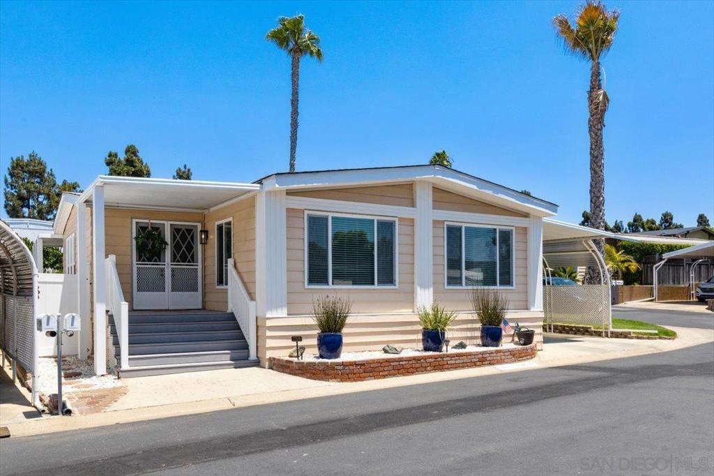 ** No Property Taxes** Light, Bright, Beach Cottage Style home! Vaulted ceilings with beams give ample light! Updated Kitchen w/Solid Granite Countertops, SS Appliances, 5 Burner Gas Stove, Convection Oven, Large Pantry w/Pull Out Shelving! Both Bathrooms are upgraded with solid Granite Countertops! Primary has separate Dual Sinks! LVP Flooring throughout home, New Carpet in Both Bedrooms! Premiere Corner Lot! Carport is large/covered and will accommodate two large vehicles. Large storage shed conveys! Backyard is private with producing Orange Tree! Washer/Dryer/Refrigerator ALL Convey! Lakeshore Gardens Community offers many social activities, fitness classes as well as informative events. Two blocks away from Carlsbad State Beach, with live music on weekends and The Camp Store with fresh pizza and local craft beer.