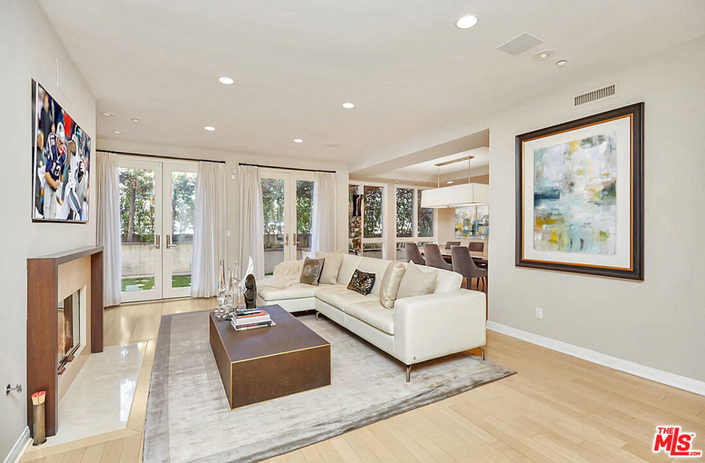Reduced to Sell Now! Serene single-level luxury condo in Prime Beverly Hills with 2-sided garden patios! Discover indoor-outdoor living at its best in this pristine 1719 sqft unit at the prestigious Almont Plaza. Ideally situated on a quiet, tree-lined street just north of Wilshire, this beautifully updated 2-bedroom, 2.5-bath condo feels like a private home complete with lush wraparound garden patios that create a tranquil retreat in the heart of the city. Located in a secure building, this rare first-floor corner unit offers complete privacy and a seamless flow for relaxed living and elegant entertaining. The expansive layout features a formal double-door entry, gracious foyer, and large living room with fireplace, custom built-ins, bar and walls of glass that bring the gardens in. The oversized formal dining room sets the stage for memorable gatherings. A bright, airy kitchen opens to the patio and is outfitted with top-tier appliances including a Sub-Zero fridge, white cabinetry, a spacious breakfast area, and side-by-side laundry. Designer finishes, wide-plank wood floors, and oversized windows add sophistication throughout. The generous primary suite boasts a remodeled spa-like bath and an oversized walk-in closet. The second bedroom is equally spacious with a private ensuite bath, plus there's a beautiful powder room for guests. Additional highlights include a full security system, 2-car side-by-side parking in a gated secured garage, and access to luxurious building amenities: a stylish lobby, gym, sundeck, and meeting room. Water and EQ insurance included in HOA dues. Walk to restaurants and enjoy the best of the Beverly Hills lifestyle, renowned shopping, entertainment, Beverly Hills school district, police and fire. Furnishings shown in photos are excluded and have been removed. Easy to show - This rare garden gem won't last!