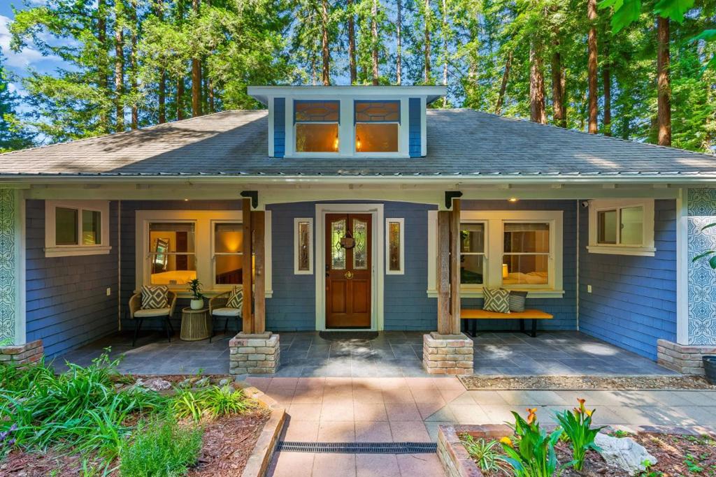 This home sits on three adjacent parcels, offering a rare opportunity to own 1.2 acres on the San Lorenzo River. Wake up in the trees and end the day with your feet in the river at this redwood retreat in the heart of Ben Lomond. This contractor owned Craftsman also has a private walking path down to your own swimming hole. The 3BR/2BA main home blends vintage charm with thoughtful modern upgrades, while the lower level offers a fully built-out second unit complete with its own kitchen, full bath, living room, and bonus room ideal for guests, rental income, or multigenerational living. A spacious tandem garage with soaring ceilings provides potential room for a boat, RV, or large workshop. Enjoy morning coffee on the treehouse-style balcony surrounded by majestic redwoods, or explore nearby hiking trails, Highlands Park, and downtown Ben Lomond all just minutes away. Whether you're looking for serenity, flexibility, or a true indoor-outdoor lifestyle, this riverfront gem is ready to welcome you home.