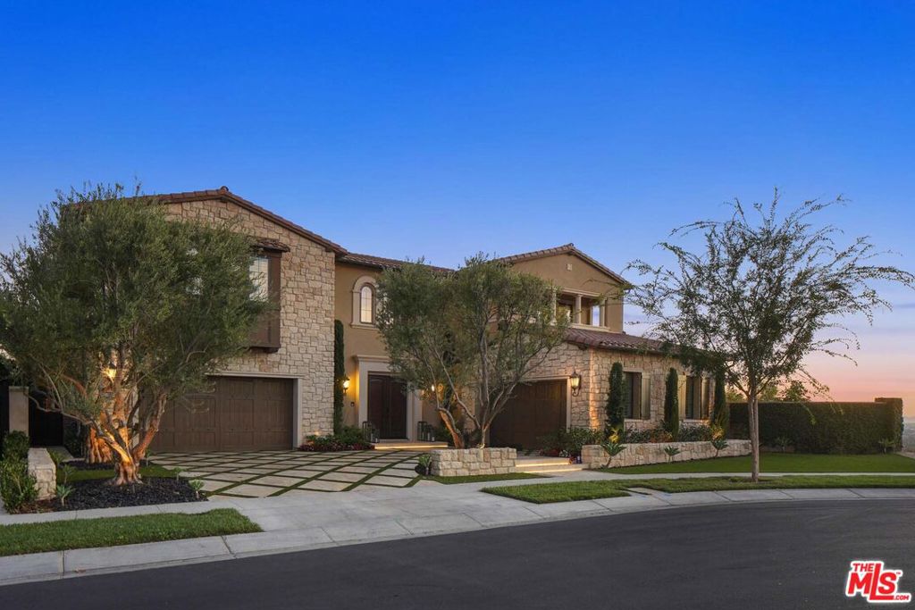 Arguably the most impressive property ever built in Irvine. An exceptional offering that combines the ultimate in interior finishes and exterior amenities, all located within the prestigious 24-hour gated community of The Grove at Orchard Hills. Recently built in 2019 on a corner lot with only one neighbor, the home impresses with a soaring foyer with dual curved staircases framed by incredible panoramic city and canyon views. Rustic exposed wood-beamed ceilings highlight the open living and dining areas, with sliding floor-to-ceiling allowing a plethora of natural light. An unparalleled transition of indoor/outdoor living, the current owners spent $1.5 million on a one-of-a-kind entertainer's yard boasting a conversation pit with built-in fireplace surrounded by a massive wrap-around infinity-edge resort-style pool and spa, multiple fire features, grassy yard, outdoor kitchen, and multiple lounging areas. The chef's kitchen is replete with dual islands with built-in breakfast bar seating and top-of-the-line Wolf appliances. Upstairs the oversized primary retreat showcases a see-through dual-sided fireplace with separate living area, stunning coffered ceilings, private balcony, and a spa-like ensuite bathroom with double vanity sinks and large custom walk-in closet. 4 additional guest bedrooms with ensuite baths and ample space, all of which are centered by a generous bonus-room and covered view deck. Experience the utmost in contemporary living within a convenient location, top-rated schools, unmatched quality and design, and high-efficiency upgrades including solar panels. 4-car garage.