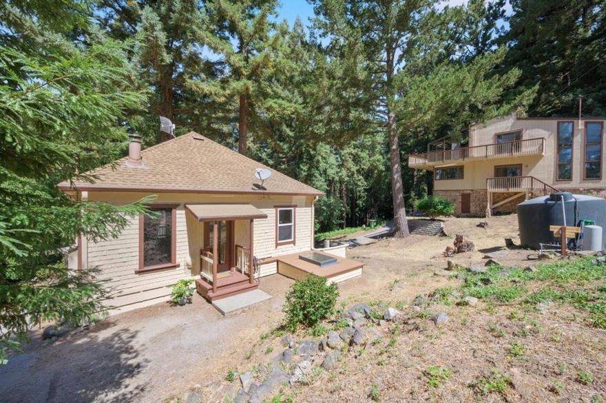CHARMING 2-BDRM 1.5-BA COTTAGE | SEPARATE 2-STORY WORKSHOP | GATED DRIVEWAY  Live a beautiful life among redwoods on 10.83± ac. and trails! Welcome to a great community! Enjoy peaceful mornings on your deck surrounded by nature and sunsets that shine through the trees. The main home offers an open living room-kitchen, lots of light, and partially finished basement w/half bath, laundry area, and extra space for gym, hobby space, storage, etc. A separate 2-story workshop/studio is a dream for creators, builders, or gearheads alike. Its oversized barn door allows for large equipment while the upper-level hoist and spiral staircase make the space functional and fun. Imagine this as your art studio, woodworking haven, or even a future guest suite or office. Upstairs is full of natural light and treetop views that inspire!  Fresh exterior paint!  Extremely convenient drive-through driveway encircles both home and workshop. Top schools nearby, and, close to grocery shopping at Summit Store, plus just 12± mi. to Capitola taking the famed backroad, Soquel-San Jose Rd.! Previously rented at $2,600/mo., income potential.  Whether you're seeking a cozy home, a weekend retreat, or a place to build and create, this property invites you to live, work, and play in harmony with nature.