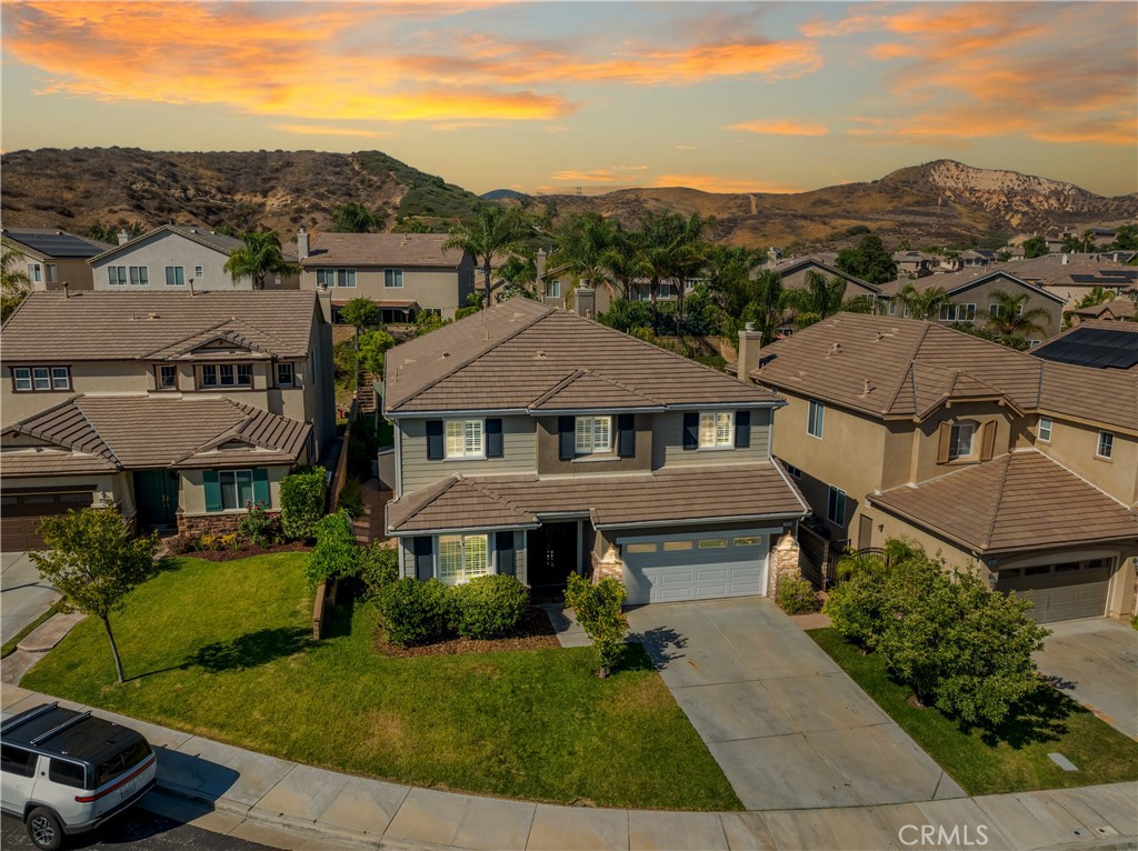 Welcome to this beautifully maintained 6-bedroom, 4.5-bathroom home tucked away in a quiet cul-de-sac in one of Santa Clarita’s most desirable neighborhoods. Designed with both comfort and functionality in mind, this spacious home features hardwood floors, tile, and elegant shutters throughout the first level. The main floor includes a full bedroom and bathroom — perfect for guests or a Mother in law suite! — plus a convenient half bath for visitors. Upstairs, you'll find four generously sized bedrooms connected by Jack and Jill bathrooms, a loft, and a dedicated laundry room. The luxurious primary suite offers a retreat-like experience with a massive en-suite bathroom and dual walk-in closets.
Additional highlights include a 3-car garage, tankless water heater, and a whole house fan. The backyard is a true oasis, featuring a lush garden with an impressive variety of fruit trees and vines — including figs, apples, lemons, blackberries, strawberries, and grapes.
Located within a top-rated school district, this home offers a perfect setting for family living in a safe, vibrant community. NO MELLO-ROOS! A rare gem — come see it for yourself!