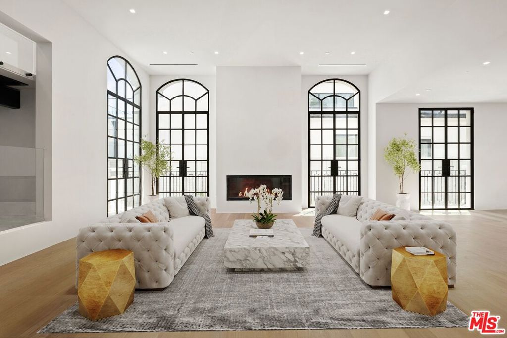 Step into the epitome of luxury living in the heart of Brentwood. This stunning French modern masterpiece, built with exquisite craftsmanship, boasts 6 bedrooms, 9 baths, and spans over an impressive 9,300 sqft across three levels. Every detail of this residence has been meticulously thought out, creating a truly unparalleled living experience. As you step through the grand entrance, soaring ceilings and custom Semco and hardwood flooring welcome you, while abundant natural light cascades through every corner. Seven fireplaces adorn the expansive living spaces, imbuing each room with a warm and inviting ambiance. The chef's kitchen is a culinary haven, with all countertops crafted from imported marble and granite, and all cabinetry meticulously designed by Pedini. The kitchen is equipped with Wolf range and cooktop, double Miele dishwashers, double Wolf ovens, double Sub-Zero fridge and freezer and a butler's kitchen that all open to the cozy family room. The estate is also equipped with two laundry rooms, a pool bath with an infrared sauna, Crestron home automation, Lutron lighting, and a state-of-the-art security system with cameras. The attention to detail is unmatched. Completing the main level is a formal living room, formal dining room, a full bar with a beverage cooler, wine cooler, and ice maker and an executive home office. As you make your way up the floating staircase, you will encounter three en-suite secondary bedrooms, a primary bedroom, secondary living room and a staircase that takes you to the roof deck where you will enjoy breathtaking panoramic and peek-a-boo ocean views. The primary retreat features a fireplace, a private balcony overlooking the yard, an oversized walk-in closet and a spa- like bath with a soaking tub, his and her vanities, steam standing shower, and toilets. Every upstairs en-suite bathroom pampers with heated flooring, enhancing the comfort of this already opulent home. With 10 A/C zones, you can also customize your climate preferences in each room. The basement level offers entertainment aplenty with a state-of-the-art home theater, a home gym, a full bar with a dishwasher, ice maker and under counter fridge/freezer, a temperature-controlled dine in wine cellar, three car garage and two additional en-suite bedrooms. Effortlessly connecting all floors, including the roof deck, is an elevator with four stops. Outside, the backyard oasis beckons with a loggia, expansive grassy yard, and a pool with a spa perfect for entertaining guests or enjoying serene moments of relaxation.