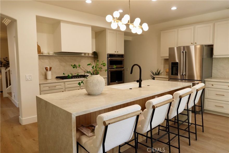 Welcome to 173 Parkside Drive, Simi Valley – a beautifully updated residence situated in the Botanica community in the prestigious 24 hour guard-gated Long Canyon community. This spacious 4-bedroom, 2.5-bathroom home offers 2,465 sq. ft. of thoughtfully designed living space with modern upgrades throughout. Step inside to find new flooring and fresh paint that give the home a bright, contemporary feel. The renovated kitchen is the true centerpiece, featuring modern cabinetry, new appliances, and a large island, all perfect for cooking, dining, and entertaining. The main level also includes a powder room with stylish finishes. Upstairs, a newly updated Jack and Jill bathroom showcases brand-new tile and fixtures. The primary suite is a luxurious retreat with a bathroom that offers a double vanity with white oak-style cabinetry, a standalone soaking tub, a spacious walk-in shower, and a generous walk-in closet. The exterior is equally inviting with clean, low-maintenance landscaping, while the garage offers built-in storage for convenience. Located in Long Canyon, residents enjoy the security of a 24-hour guard-gated entrance plus access to community pools, a recreation room, and scenic hiking trails.