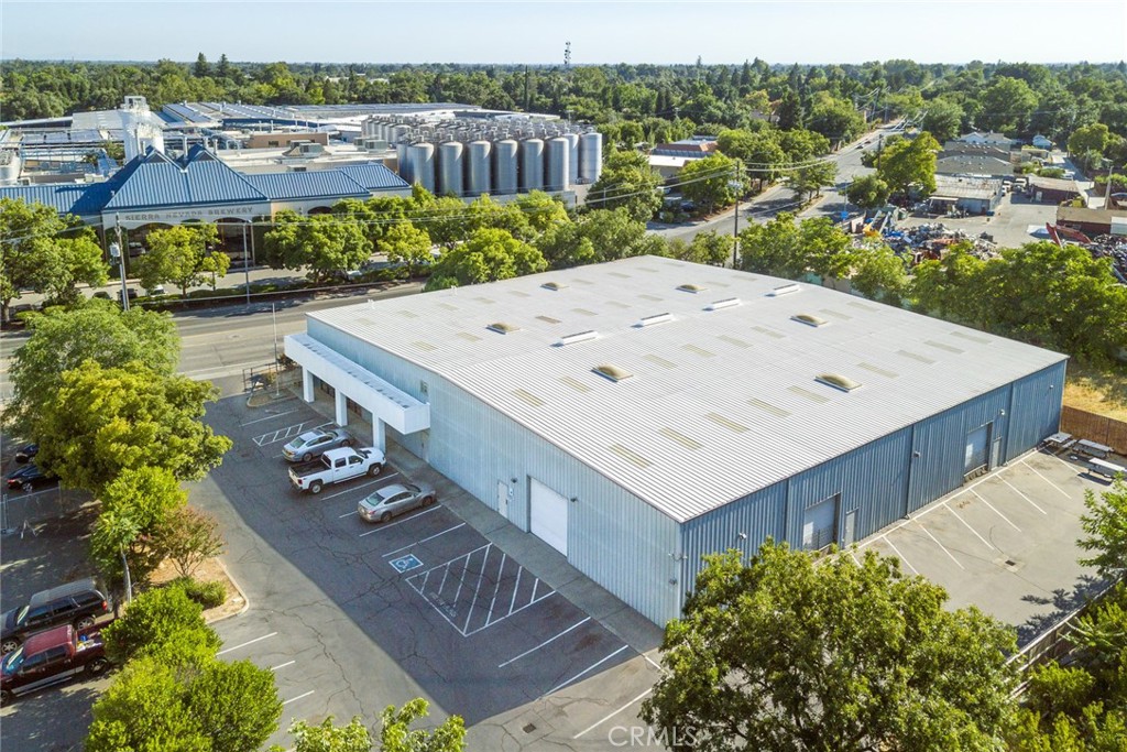 Prime Warehouse with Office/Retail Space Across from Sierra Nevada Brewery. Strategically located in a high-traffic commercial corridor directly across from the iconic Sierra Nevada Brewery, this well maintained ±21,448 SF metal warehouse offers a rare combination of functionality and visibility. The building includes ±4,000 SF of conditioned office or retail space, three restrooms, and three roll-up doors providing excellent access to the warehouse area. Property features a new roof coating applied in 2017 with an 18-year warranty, fire sprinklers and is fully fenced. Excellent visibility and access make this an ideal location with a ML zoning for a wide range of commercial & industrial users.