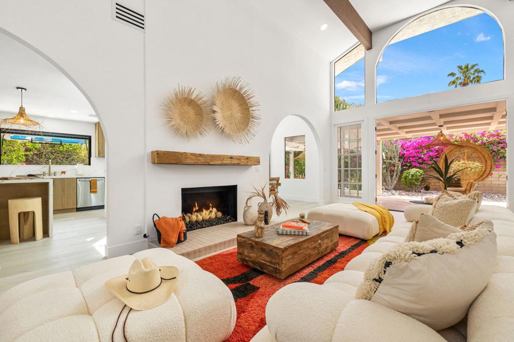 Tulum-Inspired Remodel in the Heart of Rancho Mirage with Incredible West-Facing Mountain Views!Step into resort-style living with this breathtaking, one-of-a-kind renovation in Presidential Estates--an exclusive, quiet, gated community in Rancho Mirage featuring tennis courts and a community pool.This Tulum-inspired masterpiece has been thoughtfully reimagined from top to bottom by a professional designer and team. From the moment you arrive, the brand-new concrete driveway and walkway, fresh exterior paint, new lighting, and lush landscaping set the tone for what's inside. Every detail was carefully curated to create a serene, modern oasis with an effortless indoor-outdoor flow.Inside, soaring ceilings with refinished beams and mood-lit atrium draw you into a space that feels open, airy, and welcoming. With specialty light fixtures and custom-created arches throughout, you will feel like you are on vacation every day. Other updates include premium stone composite LVP flooring, sleek new baseboards, and the removal of all popcorn ceilings which lends the home a clean, contemporary feel. The stunning kitchen features custom wood cabinetry, lovely hardware, high-end quartz countertops with waterfall edge and full backsplash, and stainless appliances including double ovens, custom stove and vent, drawer microwave, dishwasher, refrigerator, and a custom pass-through kitchen window making entertaining effortless. The formal dining room offers views of the expansive, mosaic-tiled pool and spa surrounded by lush landscaping--your own private backyard retreat. A large, covered patio offers plenty of entertaining space but also shade to cool off.The primary suite is a true sanctuary, featuring a spacious walk-in closet and a luxurious en-suite bathroom with dual vanities, a floating soaking tub, and a stunning pass-through shower, custom rock wall and high-end finishes. Two generous guest bedrooms share a beautifully redesigned Jack-and-Jill bathroom with elegant zellige tile.Adorable re-created arched bar with wine fridge, designer tile, and floating shelves. Cozy up to this stylish fireplace with hand-selected mantel.This exceptional remodel showcases impeccable craftsmanship & attention to detail in every corner. Even a convenient EV charge in garage! Let someone else do the work for you and start enjoying now! All of this is offered with a low HOA fee in one of Rancho Mirage's most desirable communities close to shopping and dining.
