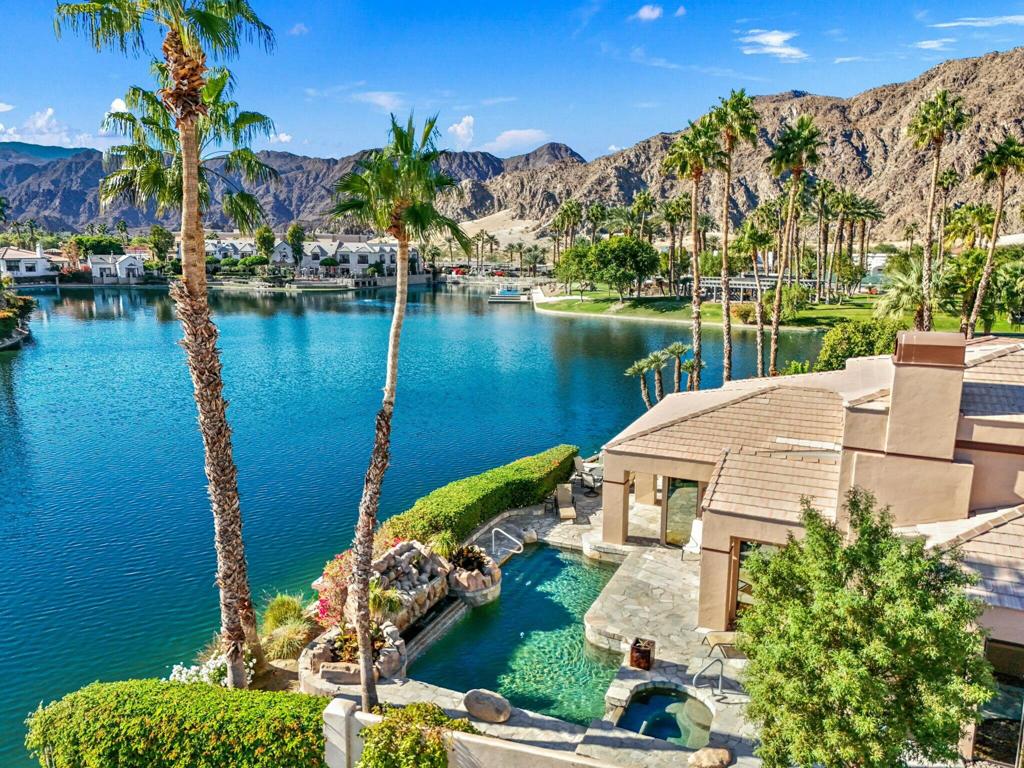 Enjoy lake life in the desert in coveted Lake La Quinta! This stunning lakefront desert retreat offers a tranquil sanctuary that will transport you to pure bliss! Turnkey furnished & surrounded by unobstructed dramatic South & West mountain & lake views this 4B & 4BA, including detached casita & approx. 3100 SF home exudes the desert lifestyle. Open & bright w/ walls of windows showcasing stunning views this home offers the perfect flow for entertaining or your private desert escape w/ spacious great room & adjacent dining room. Entertainers kitchen w/ gorgeous Cambria quartz counters, center island & breakfast bar seating. It opens to the family room w/ more amazing views & wet bar for added allure. Retreat to the spacious primary suite, where you'll wake up to stunning, picture-perfect views. The light filled primary bathroom w/ dual vanities, soothing tub, shower & walk-in closets. Guestroom w/ en-suite bathroom & guestroom/office & bathroom. Private guest retreat detached casita off of front courtyard w/ kitchenette & bathroom. The backyard is a true desert oasis offering the perfect setting to relax & unwind. Spend sun-soaked days by the sparkling pebble pool & spa or relish in the beauty of the desert sunsets over the shimmering lake w/ unparalleled mountain views. Live the desert lifestyle close to dining, shopping, world class golf & festivals! Lake La Quinta offers 24-hour guard gated security, tennis/pickleball courts, & bocce ball. Rates vary by month. Currently Available Nov 2025-Feb 2026 & April 2026
