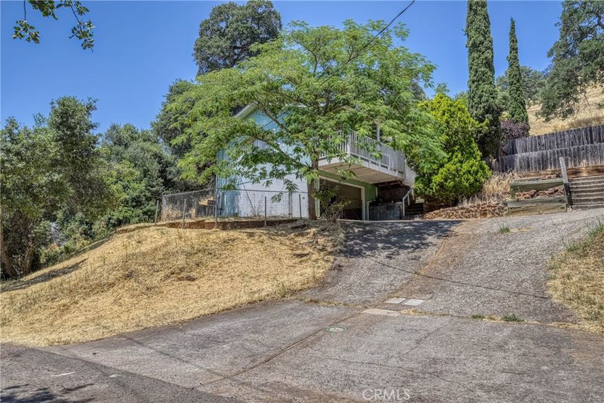 Opportunity awaits for you to get your very own affordable 2 bedroom 1 bathroom, 1,056 sq ft home in Clearlake Oaks. Shared driveway leads you to parking/garage under house with laundry hook-ups. Fenced yard, cement patio in backyard with a wood deck. Great view of the mountains out the front room window. Front room has wood laminate flooring, ceiling fan and slider to deck along with a fireplace. Dining room has a ceiling fan. Kitchen features electric glass cook-top stove, microwave, dishwasher and dual sink. 2 bedrooms, one with laminate flooring and ceiling fan, one with carpet, ceiling fan and access to attic. Full bathroom with a large vanity and tiled flooring. Be to I5 in a hour or HWY 101 in a hour. Enjoy the lake, fishing, watersports, etc...