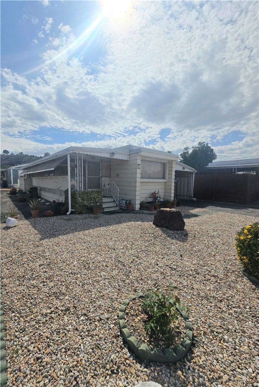 CHARMING HOME IN A 55 PLUS COMMUNITY Home Features

This delightful mobile home, nestled in the peaceful east side of Hemet, offers an inviting and comfortable living space for those aged 55 and over. The home includes: 1 Bedroom, 1 Bathroom: Perfect for singles or couples looking for a cozy retreat. Enclosed Porch: Enjoy your morning coffee or an evening read in this serene outdoor space. Little Yard: A small, manageable yard allows for gardening or simply enjoying the outdoors. Side Carport: Convenient parking with added protection from the elements. Shed for Additional Storage: Extra space to store gardening tools, seasonal items, or hobbies. Community Amenities This rent-controlled community offers a variety of amenities for residents to enjoy: Heated Pool and Hot Tub: Relax and unwind in the community pool or enjoy a soak in the hot tub. Library: Find your next great read or participate in community book clubs. Large Clubhouse: A perfect gathering space for social events, activities, and meetings. Located in a vibrant neighborhood, this mobile home offers both comfort and convenience, making it an ideal choice for those seeking a peaceful yet active lifestyle in their golden years.