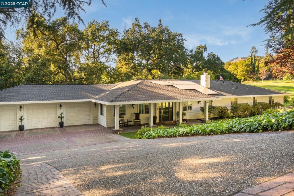 Thoughtfully updated throughout, this exceptional single-level home enjoys a premier setting on the 12th hole of Roundhill Country Club, surrounded by mature trees w/ direct golf course access. This remarkable residence features 4 bedrooms, 3.5 bathrooms, formal living & dining rooms + an open-concept kitchen & inviting family room w/ a wet bar. The gourmet kitchen is a chef’s dream, showcasing a spacious center island, 6-burner gas range w/ hood, abundant cabinetry, a wine fridge, and a skylight that floods the space with natural light. French doors extend the living space outdoors, creating a seamless indoor-outdoor flow. The luxurious primary suite offers a spa-like retreat with Calacatta marble bath, heated floors, dual vanities, a soaking tub, a walk-in closet, & designer lighting. Additional property highlights include a welcoming front porch, 2 fireplaces, rich hardwood floors, crown moldings, a 3-car garage with ample storage, and a thoughtfully updated common bath w/ direct outdoor access. This private gated property is complete with a resort style backyard, private irrigation well for landscaping and a brand new pool built in 2021 complete w/ a spa & waterfall. All set in a coveted Roundhill location near parks, Mt. Diablo, freeway access & award-winning SRV schools.
