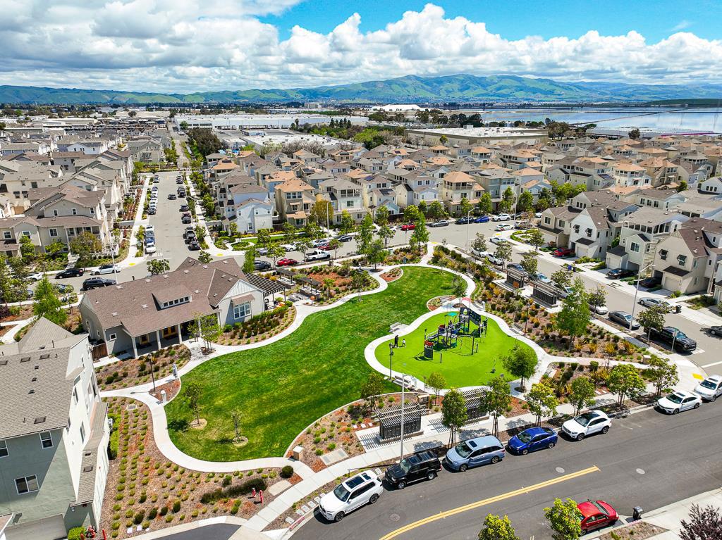 Unbeatable value in the Bayshore community! This 2017 single-family home offers 3 spacious en-suite bedrooms, each with a private bath, plus a guest half bath. The contemporary layout includes a ground-floor bedroom with a full bath which is ideal for rental or guests. The open kitchen features premium countertops, stainless steel appliances, FOTILE range hood, GAS stove, and abundant cabinetry, seamlessly connecting to the dining area and covered patio for effortless indoor-outdoor living. The primary suite offers a walk-in closet and luxurious bath with dual sinks. Additional highlights include recessed lighting, abundant natural light, central heating & A/C, energy-efficient washer/dryer, and a 2-car side-by-side garage. The Bayshore community provides a park, kids playground, and clubhouse. Conveniently located near Meta, Tesla, Lucid, and Logitech, with easy access to Dumbarton Bridge and I-880. Close to Costco, Safeway, FoodMaxx, and Tesla Superchargers. Explore nearby Don Edwards Wildlife Refuge with trails and open space. Dont miss this exceptional home
