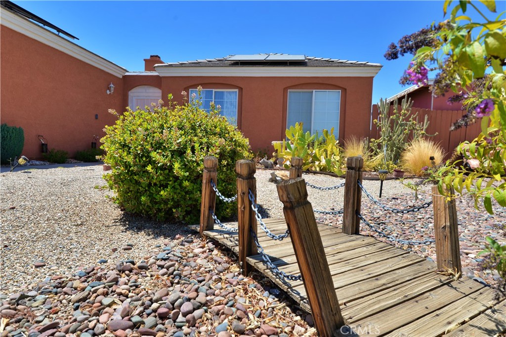 Welcome home to high desert living on a private cul-de-sac! Located on an oversized 10,000 square foot lot you'll have plenty of room to roam. Front gated yard with walkway to a private courtyard/seating area is a nice space to enjoy year round. Upon entry, a formal living room for entertaining and hallway lead to each of the 4 bedrooms. Combination tile flooring in high traffic areas and carpet is well cared for. Kitchen offers solid surface counters, high ceiling, window for natural light and custom lighting. Directly off the kitchen is a laundry room with plenty of storage. Family room has a custom ceiling fan, corner fireplace and french doors that open to an enclosed patio. Dining area is large enough to accomodate 6 place settings comfortably. Guest bath was recently improved with modern tile and colors. Property is situated with the front door facing east for morning sun. Property is within an hour and half of the California coast, mountain resorts and Nevada's state line. A must see on your home tour.