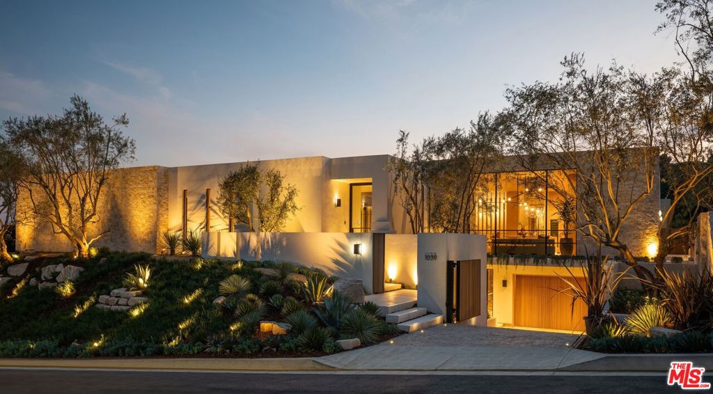 Experience timeless elegance in the exclusive Trousdale neighborhood of Beverly Hills. This organic estate designed by renowned designer Charles Infante, weaves his experience in film to create a narrative fit for entertainment and curated for elevated living in every possible way. Spanning 10,000 square feet, this architectural masterpiece showcases rich natural tones with Portuguese limestone, Italian Navona travertine, white oak paneling and floors, organic custom plaster walls, and motorized custom steel windows. Sleek lines perfectly frame cinematic city-to-ocean views. Inside, the main living spaces are open and airy, with walls of glass that fully pocket to create a seamless indoor/outdoor flow to the pool, spa, and patio. The expansive living room, dining area, and both the main and chef's kitchens are designed for grand scale living and entertaining. Four ensuite bedrooms offer refined comfort, in addition to a spacious, tranquil primary suite with motorized walls of glass, panoramic city views, and a spa-style bath. Luxurious amenities include a sleek gym with sauna, a temperature-controlled wine display, and an epic entertainment lounge with a sunken conversation pit, full bar, and state-of-the-art theater. The fully finished showcase garage features a car turntable; perfect for showcasing your collection. This is your moment to live above it all, in a home that sets the new standard for Trousdale living.