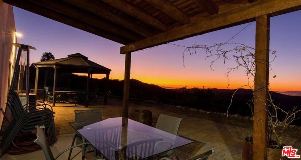 You have just discovered the premier rare sanctuary in Malibu, where serenity meets stunning natural beauty. This magnificent 19 acre ranch property offers unparalleled views of both the Pacific Ocean and the surrounding mountains. Located just 3 miles from the beach, this home serves as the perfect retreat from city life, while still offering the convenience of Malibu's finest amenities. Ideal for animal lovers, the estate includes ample space for horses and other animals, with secure dog-friendly fencing. The main house boasts a spacious kitchen with top-of-the-line appliances, while both homes feature luxurious high-end mattresses and views from every room that will take your breath away. The guest house features newly installed pine kitchen counter tops, stove and shower. Step outside to enjoy a peaceful evening by the fire pit on the stone patio, or simply take in the surrounding beauty from your private paradise. The property is available on the whole for $19,995/ month or the main house or guest house can be leased separately. The main house is available for lease at $14,995 per month, or you may opt for the guest house at $6,995 per month. *The garage and storage unit are not included in a lease price, but may be included for $4,995* For leases of two years or more, solar panels and a backup battery can be installed free of charge, offering both convenience and sustainability. This is truly a rare opportunity to lease a retreat that combines the best of Malibu's breathtaking landscapes with a lifestyle designed for comfort, peace, and connection to nature. THE PROPERTY IS ALSO AVAILABLE FOR PURCHASE AT $4,799,95 (which includes a 1600 sqft 1 bedroom flex space. Is permitted as a barn.