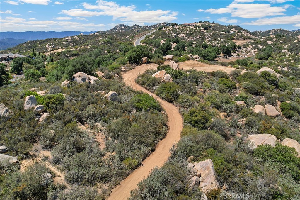 STUNNING 5-ACRE PARCEL WITH MASSIVE VIEWS OF THE LA CRESTA VALLEY & MAJESTIC LOCAL MOUNTAINS. If you are looking for a parcel to develop quickly, this one checks those boxes! It has a WATER METER already installed, providing a huge discount toward building costs. Also available are the engineered GRADING PLANS and Architect-designed custom HOUSE PLANS. The parcel has been recently cleared to provide an easy drive and view from the potential building pad. It is located in highly desired Tenaja, a Community Service District (not an HOA), on the stunning Santa Rosa Plateau, home to multi-million-dollar estates and ranches. When you visit this site, you will be greeted by ancient oak trees, gigantic boulders and gentle terrain. With further clearing, you will have an abundance of usable land, upon which to build your dream estate. See this one today! It’s easy to tour and well worth the visit! Get ready for the AWESOME VIEWS! *****SANTA ROSA PLATEAU: 5-acre minimum parcels (10-acre minimum in SR West), just minutes to schools, restaurants, hospitals, grocery stores, 15 Fwy & Temecula Wine Country. Enjoy this peaceful ranch community w/no commercial businesses, robust social activities, miles of private community trails & 1000s of acres of Ecological Reserve…All less than 1.5 hours from LA, SD, OC, Palm Springs & Big Bear. Discover the country, yet convenient, lifestyle of La Cresta, Tenaja & the Communities of the Santa Rosa Plateau!