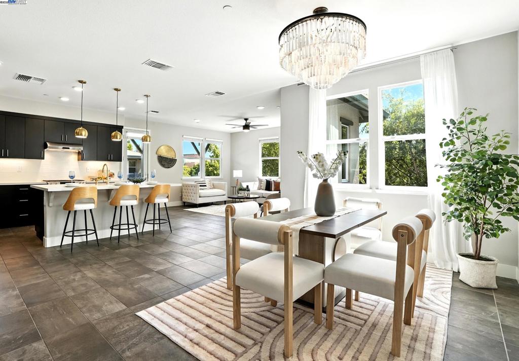 Rarely available, Symmetry Model 4 corner unit offering abundant natural light, tree-lined views, and a spacious great room with open kitchen, dining, and living room. This nearly new townhome style condo includes over $75,000 in luxury upgrades, including stunning chandeliers, modern staircase, premium flooring, window treatments, A/C and built-in Ethernet. Host gourmet meals with friends in the chef’s kitchen featuring Bosch and new KitchenAid appliances, deep stainless-steel sink, hands-free brass faucet, and a 5-burner gas range – perfect for entertaining! Retreat upstairs to your primary suite with a spa-like bath with soaking tub, and spacious walk-in closet. Enjoy morning coffee on the private patio and the convenience of a 2-car garage. Located in a highly sought-after Alameda Landing, just blocks from the new waterfront park and playground, and the Cross Alameda Trail, where one can bike in minutes to the Ferry station to SF or Oakland. Close to Jack London water taxi, Caltrain, freeways and Bay Bridge. Exceptional size, quality, convenience, and lifestyle – at a value that’s hard to beat at this price! Buy now and refi for free if rates drop even more!