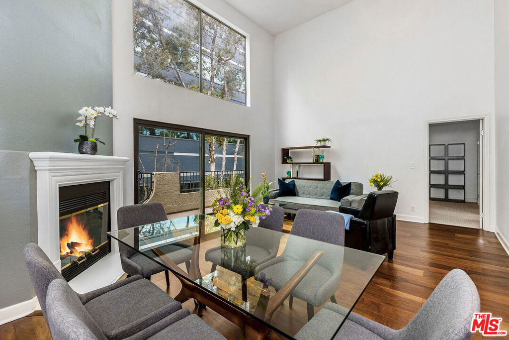 Discover Your Dream Home: A Top-Floor Westwood Oasis with a Private Rooftop DeckWelcome to a truly unique living experience! This exceptional 2-bedroom, 2-bathroom top-floor unit is bathed in natural light, thanks to its breathtaking 20-foot ceilings and massive floor-to-ceiling French doors and windows. The open-concept floor plan feels spacious and airy, complete with a decorative fireplace and ample storage. Step outside and enjoy incredible private outdoor spaces. The main living area and the primary bedroom both feature their own balconies. A staircase leads up to a perfect nook for a home office, work-out, music area and opens up to a stunning, private rooftop deck perfect for relaxing, grilling and entertaining. The bedrooms offer generous closet space, and both bathrooms are elegantly finished with floor-to-ceiling travertine tile. The unit includes a washer and dryer and two tandem parking spots, with plenty of street parking available. Located in a highly desirable Westwood neighborhood, you'll have easy access to UCLA, Century City, and Beverly Hills, with Silicon Beach and Santa Monica just a short drive away. You're also just a few blocks from Sprouts and a variety of popular local restaurants and amenities. The building also features an attractive lobby and a spacious common-area deck with beautiful city views.