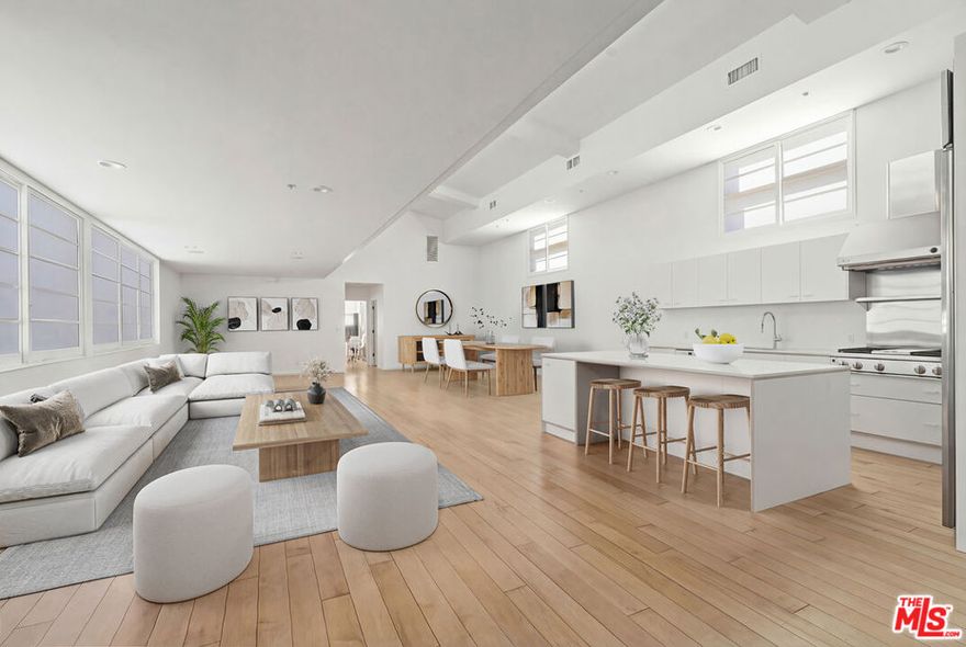 Step into a rare Abbot Kinney showpiece where architecture, light, and true live/work flexibility come together in one unforgettable space. Designed by renowned architect Mark Mack, this striking 3BD/3BA residence offers approx. 3,269 SF in a secured, well-maintained 7-unit complex just a short stroll to Venice's best shops, cafes, restaurants, and galleries. Soaring ceilings and abundant natural light set the tone, complemented by hardwood floors throughout. The main living level features an open-concept layout with custom cabinetry, high-end appliances, and generous entertaining areas. The primary suite is privately positioned away from the main living spaces, while two additional bedrooms offer creativity for lounging, study, or creative use. A dramatic top-level loft with floor-to-ceiling windows provides an inspiring office, den, or flex space. On the first level, an expansive bedroom with en-suite bath (also suitable as an additional flex space) opens directly to a wraparound garden with multiple seating areas and fire features perfect for relaxing, entertaining, or working indoors/out. Additional highlights include in-unit laundry, a private two-car garage, plus additional secured parking. With residential and commercial zoning, this one-of-a-kind home adapts beautifully as a residence, workspace, or both right in the heart of Abbot Kinney.