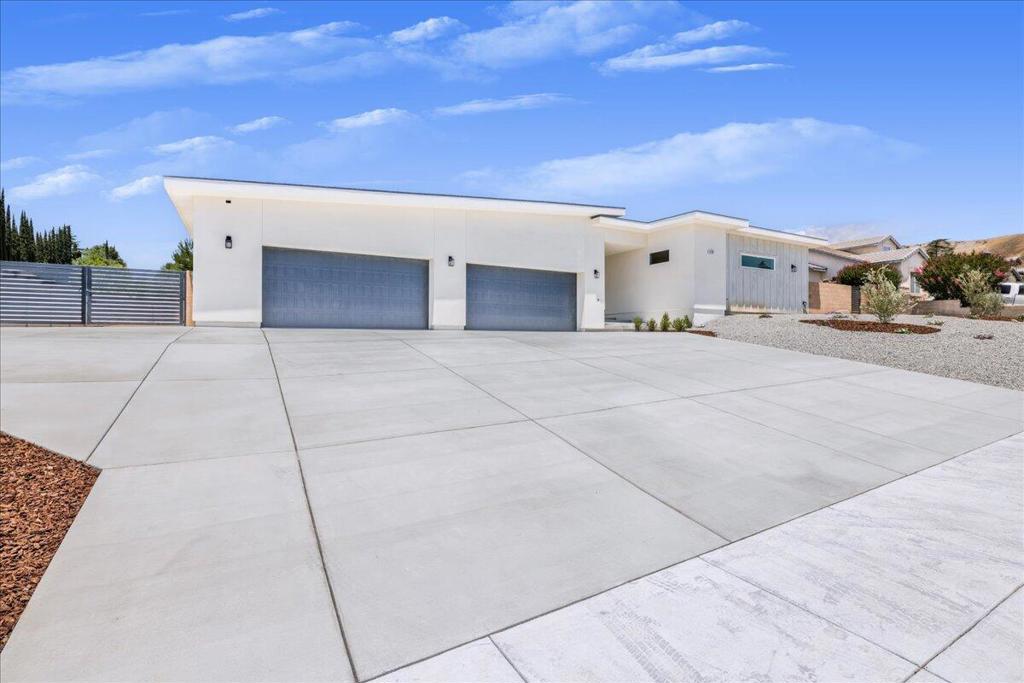 Experience luxury and exclusivity in Banning's premier neighborhood with this brand-new custom home that redefines sophisticated living. As you arrive along the expansive driveway--complete with RV parking, hook-ups, and an oversized 4-car garage--imagine the endless possibilities on nearly half an acre of pristine land. Walk into your private, enclosed courtyard, an ideal canvas for a sparkling pool and serene outdoor retreats. Step inside to a dramatic open living space where soaring ceilings and a refined neutral palette create an ambiance that is both modern and calming. The intelligently designed layout features four ensuite bedrooms and 3.5 baths, perfect for family living, while a dedicated casita with an additional bedroom and bath offers flexible options as a guesthouse, game room, or in-law suite. At the heart of this home lies a gourmet kitchen, boasting a sleek quartz island and top-of-the-line stainless steel appliances--a chef's dream for hosting and everyday delights. The spacious great room is crafted for gatherings and memorable celebrations, seamlessly blending indoor and outdoor living. Enhanced by smart home features--including Wi-Fi, built-in speakers, doorbell video, security cameras, and an EV charger--this eco-friendly haven also offers a PAID solar power system, dual tankless water heaters, and three HVAC heat pumps. Discover a lifestyle where every detail exudes elegance, comfort, and a sense of endless possibility. Welcome to your unforgettable escape.