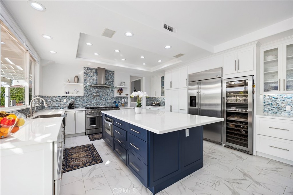 VA ASSUMABLE LOAN 2.65% Nestled in The Greens, in the prestigious gated community of Coto de Caza, this renovated 5-bedroom, 4.5-bathroom residence offers modern elegance and a seamless blend of luxury, comfort, and serene views; step inside to soaring ceilings, new flooring, and abundant natural light. The gourmet kitchen is a showstopper, featuring custom cabinetry, all-new stainless steel appliances, sleek quartz countertops, and a large island with bar seating—beautiful and functional. The open-concept design flows effortlessly into the family room, making it ideal for entertaining. New sliding doors invite natural light indoors, connecting your private backyard oasis, creating the perfect blend of indoor-outdoor living. Whether you cozy up by the fire pit, relax in the jacuzzi, dip in the pool, or dine under the stars—you'll enjoy picturesque views of the rolling hills. The backyard features 20 different fruit and citrus trees, while custom planter boxes provide space for homegrown herbs, vegetables, or flowers, adding to the home’s appeal.
The primary suite retreat boasts a private balcony, fireplace, and spa-like ensuite with dual vanities, a soaking tub, and an oversized walk-in shower. The bonus room has been converted into a home office, and an additional bedroom with an ensuite bath, adds versatility—ideal for guests, multi-generational living. This home has fully paid dual solar panels, ensuring energy efficiency without sacrificing luxury. Residents enjoy exclusive community amenities, including resort-style pools, a clubhouse, a fitness center, two championship golf courses, an equestrian center, hiking and riding trails, pickleball, tennis, and sports courts. This is an incredible opportunity to experience the best of elegant living and an active lifestyle in one of Southern California’s most sought-after communities. Take a short drive and explore the famous California beaches of Laguna, Newport, and Dana Point, perfect for sun-soaked days, surfing, and waterfront dining and shopping. A couple hours drive to the scenic mountains of Big Bear or Lake Arrowhead for skiing, hiking, and year-round outdoor adventures. For a change of scenery, the stunning desert landscapes of Palm Springs and Joshua Tree provide a tranquil retreat with breathtaking vistas, world-class resorts, and endless recreation. Come live the California dream—schedule your private showing today!