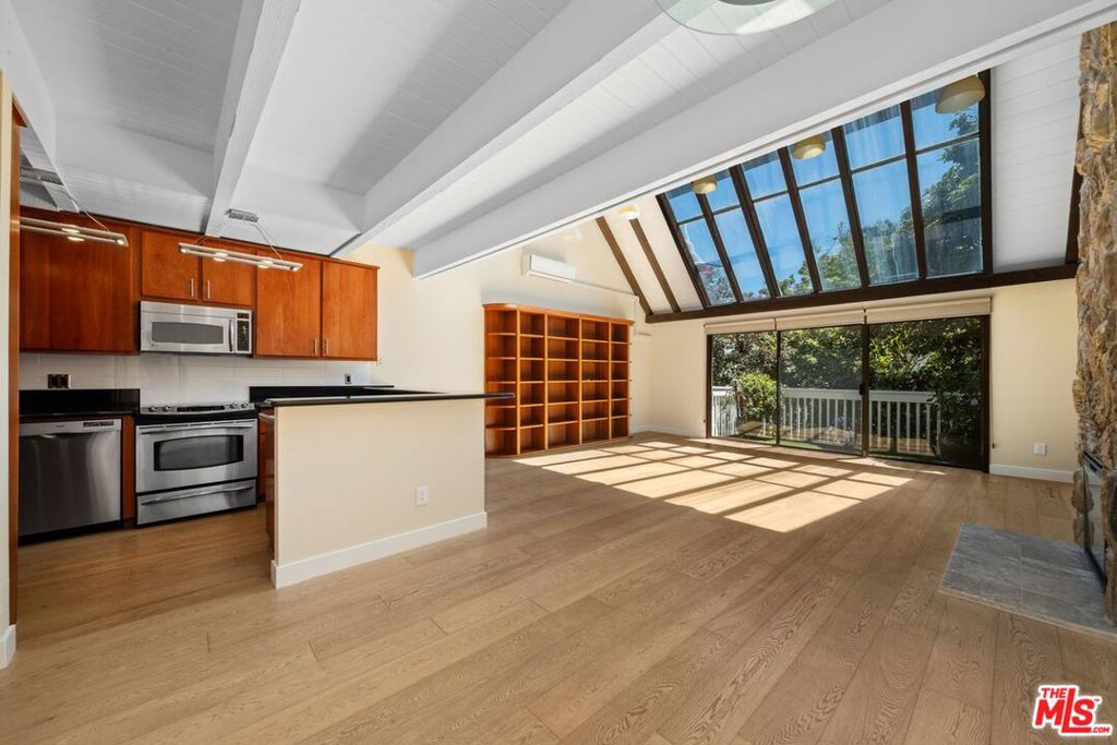 Enjoy beach living in this beautifully remodeled 2 bedroom/3 bath + Loft Townhome-style condo on the coveted Marina del Rey Peninsula. Steps to the sand...this dramatic 3 story home is located on a "walk street" and features new hardwood floors, soaring vaulted beamed ceilings and an abundance of skylights that fill the home with natural light. The open concept living area includes a stone fireplace and opens to a private balcony surrounded by lush garden and treetop views. Both bedrooms offer balcony access, and a large loft with its own bathroom and closet provides flexible space for an additional bedroom or a home office. Enjoy stunning canal views from the expansive private rooftop deck - perfect for entertaining or relaxing in the sea breeze. This intimate, well-maintained 8 - unit building offers a peaceful setting with secure two-car parking. Short distance to the best of Marina Del Rey and Venice - boutique shops, Cafes, and top dining spots. Live in the heart of Silicon Beach!