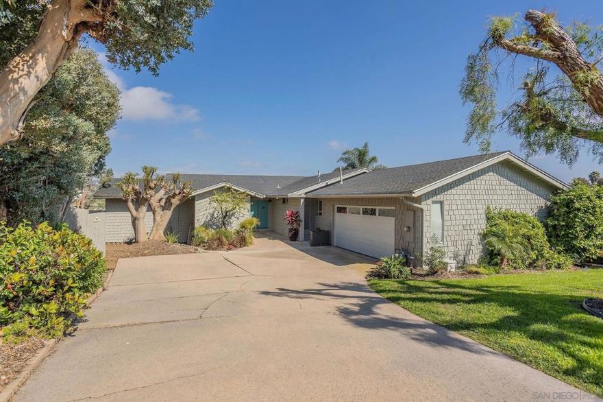 Fully remodeled in 2019! Stunning single-level home with an attached two-car garage located within the heart of Carlsbad. Situated on an ample .39-acre lot with gorgeous VIEWS and ADU potential. Incredible view of the Carlsbad hills visible from the master bedroom, living room, dining room, kitchen and office. One bedroom and bath could be completely secluded with its own entrance. This amazing residence features neutral paint and trim, a cozy fireplace, a large and bright office, and engineered hardwood flooring. Vaulted ceilings with large windows and French doors in the dining room, living room, and primary bedroom bask the home in an abundance of natural light. A beautifully appointed Chef’s kitchen boasts quartz countertops, sleek stainless-steel appliances, recessed lighting, and modern cabinetry with breakfast counter seating that opens to the living area. A spacious primary suite offering deck access, a walk-in closet with a nice wood finish, and its own spa-like en-suite bath featuring dual sinks and a custom walk-in shower. Outdoor living has been extended to the Entertainer’s backyard featuring a sprawling deck with four levels of sundecks, lush landscaping and thoughtfully-designed hardscape including and peaceful and serene seating areas, perfect for entertaining and taking in the views. The lower portion of the yard offers a large level grassy area with several varieties of fruit trees, plants, and herbs including Avocado, Pomegranate, Lemon, Apples, Cherry, Apricot, Dragon Fruit, Passion Fruit, Raspberry, Strawberries, Rosemary and Thyme.