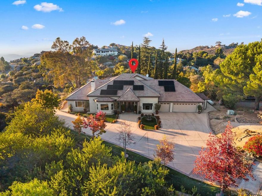 Luxurious executive home, privately situated on a hilltop gated community of Rimrock Estates. Gated driveway winds around the 2.7 acre property, leading to this stunning, fully renovated mountaintop home offerring panoramic ocean and sunset views. With $400,000 in upgrades, paid solar, and dual Tesla Powerwalls that offset the most or all of the monthly power bills. Enter through a custom wrought-iron door to an airy, open floor plan filled with natural light and porcelain tile floors. The gourmet kitchen features a large granite island, bar seating, and custom cabinetry—flowing seamlessly into the dining area with coffered ceiling and wainscoting. The spacious family room, framed by three 8-foot sliders, opens to a 2,000 sq. ft. wraparound patio—perfect for entertaining against endless views. The primary suite offers a tranquil retreat with ocean-view sitting area, walk-in closet, and a newly remodeled spa bath with soaking tub and multi-head shower. Upstairs, two bedrooms and a private deck offer versatile living options. Outdoors, enjoy four sitting areas, a jacuzzi under the stars, dual grilling stations, and lush, water-wise landscaping with succulents, turf, and fruit trees. The oversized 3-car garage with epoxy floors and built-ins completes this exceptional property. Experience the peace, privacy, and breathtaking beauty of mountaintop living—schedule your private viewing today. Water-wise landscape - with 2 areas of artificial turf, succulents, proteas, fruit trees, including Apple, Avocado, Lemon, Lime, Golden Nuggets, Orange, and Pear.