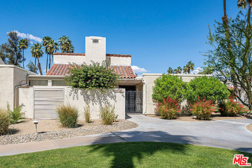 Enjoy breathtaking panoramic views from this wonderful condo located behind the guard gates of Mission Hills Country Club. Set on one of the best lots available the exposure takes advantage of stunning views of San Jacinto, San Gorgonio and the Santa Rosa Mountains along with endless golf course fairways and pools. Enjoy privacy with the huge greenbelt lot on the south side of the property and a private gated courtyard complete with a BBQ area. This contemporary designed home offers just under 1600sf with 2-bedrooms, a den with sleeping bed and 2 bathrooms. The primary suite is on the golf course with incredible views and has large closets. The art deco kitchen has a classic feel finish, solid surface marble counter tops, original appliances and great front views. The huge great / living room features volume ceilings, fireplace, wet bar and a dining area. The home is perfectly livable, move-in ready but one can use their imagination for upgrades. Private Laundry closet is inside unit. 2-car detached garage. If you have been searching for a low maintenance, contemporary home with jaw dropping views then look no further this is the one! Association offers golf, swimming pools, gym, multiple world class tennis courts, clubhouse, stores, restaurants and bars!