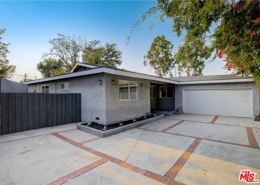 Fantastic property set back off the tree-lined street, long driveway, and two-car garage for ample parking. Updated and ready to move into, four bedrooms with office/den, three baths, perfect open floorplan, and plenty of natural light. Great indoor laundry area, updated kitchen, updated bathroom and a bonus room, perfect for anything you can imagine. Glass doors, laminate wood-like floors, recessed lighting, crown moldings, raised fireplace perfect for cozy evenings, wood cabinets with self-closing drawers, plenty of storage space, stone countertops, stainless steel appliances, and breakfast bar. The primary bedroom has a walk-in closet, direct access glass doors to the back yard, and a private bathroom with a walk-in shower. All of this and more can be yours floors are updated with laminate wood. Backyard has a custom built bbq setup. Excellent location this is a great opportunity for someone who's looking for an updated home with good ample space inside.