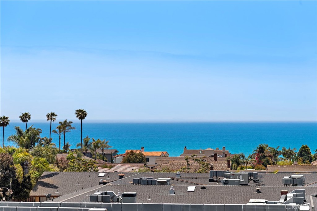 This 4-bedroom ocean view estate in Capistrano Beach, epitomizes coastal luxury, blending sophisticated design with breathtaking vistas of the Pacific Ocean. Stunning remodel in every room of this home. Dramatic foyer with high ceilings and views as soon as you step inside the front door of this home. Open floorplan with room for large gatherings and entertaining. Cozy up in either the living room or family room next to the warm fireplace and enjoy the light and bright views. Create family memories and make meals in the chef’s dream kitchen with a large island for hosting guests with views of the water. All brand new cabinets, Café appliances and a beautiful farmhouse sink. Oversized French glass doors lead to the private back yard, complete with low maintenance turf and plants. Retreat to your master bedroom with panoramic views of the ocean from your private balcony. Soak in more views from the master bath tub, separate walk in shower and dual vanity sinks. Three additional bedrooms upstairs, two with en-suite bathrooms and secondary balcony with ocean views. Enjoy the convenience of two laundry rooms, one located downstairs and one laundry room closet upstairs. Enclosed two car garage with large driveway for additional cars. Offering close proximity to downtown Dana Point, schools, Beach Road and the Shoreline.