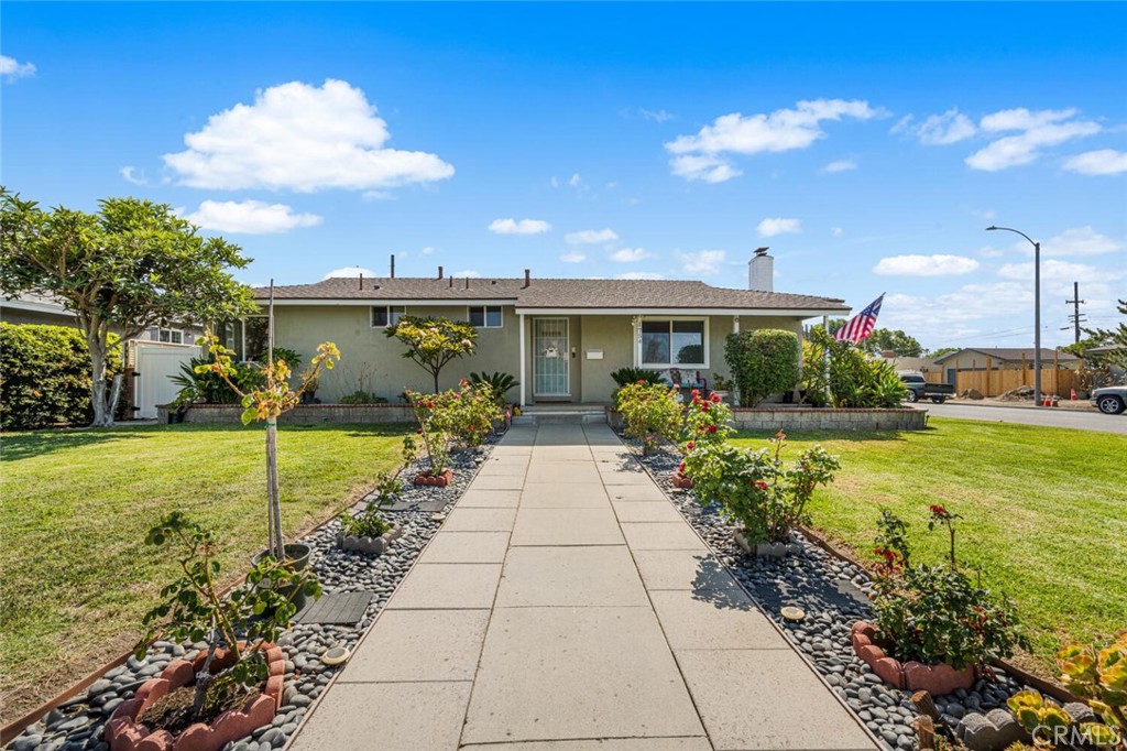 Welcome to 1754 S Norfolk Ln,, a charming residence for immediate occupancy, boasting 3 bedrooms and 2 bathrooms. This single-story home offers 1,672 square feet, situated on a generously sized 7,526 square foot lot. Located on a corner with RV parking, this property is a rare find. The open floor plan seamlessly integrates a bright living room, complete with a fireplace. The kitchen is appointed with white cabinetry, quartz countertops, a thoughtfully designed backsplash, and stainless steel appliances. A formal dining area flows effortlessly into a spacious family room, access doors from family room to both private backyard and side yard. The master bedroom has its own en-suite bathroom with a shower stall. A secondary bathroom at hallway, complete with a bathtub, shares the same attention to detail, boasting a designer tile backsplash ceramic tile flooring. Laminate wood flooring throughout the house, new tile floor in family room, recessed lighting, 2-car garage direct access to family room area. One bedroom has private access to the back yard, Well-manicured front landscaping and low maintenance of the backyard surrounded by all block walls. Property nearby Disneyland, parks, shopping and easy access to freeways. Don't miss your chance to make this home your own. Schedule your private showing today and discover all the possibilities this home has to offer.