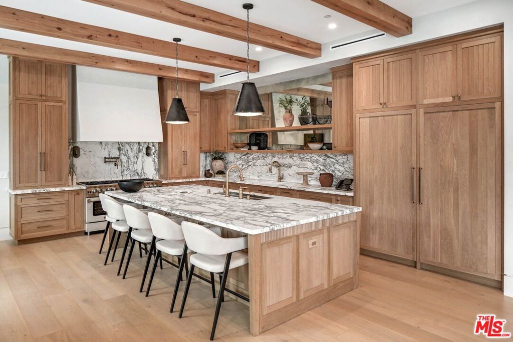 Nestled in the coveted Huntington Palisades, welcome to a masterpiece of modern luxury living. This brand new construction home is situated on a large lot and boasts an array of exceptional features, making it the epitome of refined living. Inside, discover six bedrooms and eight bathrooms, including two offices for those who seek a dedicated workspace. The primary suite is a sanctuary of indulgence, with separate his and hers closets providing a touch of opulence. Movie nights become a cinematic experience in the state-of-the-art screening room, while fitness enthusiasts will appreciate the convenience of the in-home gym. The kitchen is a chef's dream, equipped with top-of-the-line appliances from SubZero, Thermador, Miele, and a custom BlueStar range as well as a butler's pantry. Whether you're hosting an intimate dinner or a grand event, this kitchen is designed to exceed your culinary expectations. Entertain in style with an expansive backyard featuring a pool, spa, firepit, and full outdoor kitchen and BBQ, a game room that invites friendly competition and a seamless elevator for easy access to all levels. Additional amenities include a mudroom for practical and organized living as well as a RTI Control smart home system throughout. This family home is set in the cozy beach community of the Pacific Palisades, just steps to the Palisades village, schools, movie theater, restaurants, beach, bike path & hiking trails.
