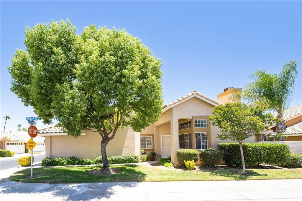 Welcome to Sun Lakes Country Club – Southern California’s Best Kept Secret! This beautifully upgraded Idyllwild model is a rare single-story, end-unit condo located in a vibrant 55+ guard-gated golf course community. Offering 2 spacious bedrooms, 2 bathrooms, and ample living space, this home is filled with stylish updates and thoughtful features throughout. Enjoy the modern kitchen with granite tile countertops, stainless steel appliances, under-cabinet lighting, and pull-out pantry shelves. The open floor plan flows into the bright living area with cathedral ceilings, a cozy stone-tile fireplace, and a French door leading to a private patio oasis- perfect for relaxing or entertaining. Additional features include LVP flooring, upgraded lighting, plantation shutters, and a 2-car attached garage with storage. Located just steps from additional guest parking, this home has been meticulously maintained. Sun Lakes Country Club offers true resort-style living: TWO 18-hole golf courses, THREE clubhouses, TWO restaurants, bar & lounge, indoor & outdoor pools, fitness centers, tennis, pickleball, bocce ball, billiards, library, and over 80 social clubs and activities. HOA dues include cable TV & high-speed internet. No Mello Roos! Conveniently located near shopping, medical centers (Loma Linda & Optum), casinos, and just 30 minutes from Palm Springs. Live where others vacation—this is more than a home, it’s a lifestyle!