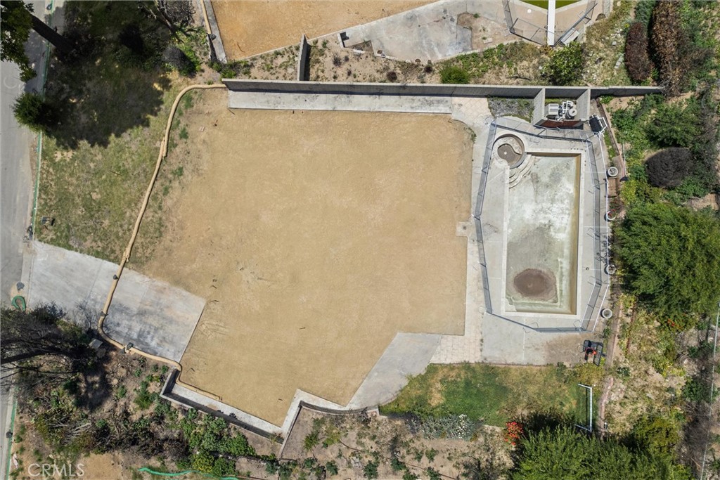 Tucked in the middle of a peaceful cul-de-sac in north Altadena, this expansive 10,010 SF flat lot offers a rare opportunity to build a new home in a serene, nature-rich setting. Formerly home to a 1,929 SF residence with 4 bedrooms and 2 bathrooms, the property was lost in the Eaton Fire. Today, it stands fully cleared and build-ready, with the concrete driveway and pool still intact. Phase 1 and Phase 2 debris removal have been completed by the Army Corps of Engineers. Surrounded by a tranquil neighborhood and just moments from scenic hiking trails, parks, and the many amenities of Pasadena, this location blends quiet residential charm with convenience and lifestyle. All utilities were previously connected—buyers to verify current status with local providers. Land value only. Drive-by only—do not access the property. Due to its status as a burn site, the lot is being sold strictly as-is. Buyers are advised to independently verify all zoning, rebuilding, and permitting requirements with Los Angeles County and relevant agencies. All information is deemed reliable but not guaranteed. Buyer to perform their own due diligence regarding future development, lot size, neighborhood designation, school zoning, utilities, and other factors.