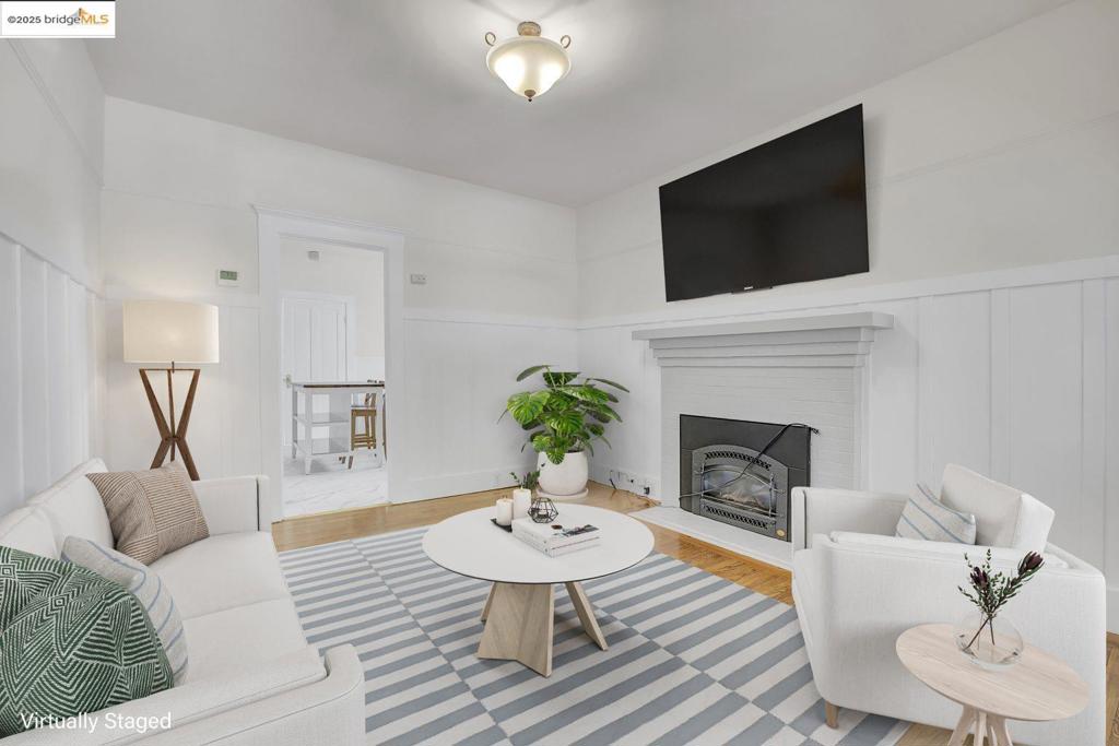 In one of Berkeley’s most sought-after neighborhoods, this stylishly updated bungalow-style home blends timeless charm with modern updates and offers a flexible layout perfect for today’s lifestyle. Upstairs, the light-filled 2bd/1ba features a formal living room with a cozy fireplace, hardwood floors, and generous natural light. The kitchen is equipped with quartz counters, stainless steel appliances, and new flooring in both the kitchen and laundry room. Fresh new interior paint throughout adds a crisp, modern feel. The bathroom has been thoughtfully updated with a new modern single-sink vanity and fixtures. The lower level offers a separate 1bd/1ba in-law unit, ideal for extended family, guests, or a work-from-home setup. With a Walk Score of 88, you’re just minutes from Berkeley’s vibrant Fourth Street district with its shops, cafes, parks, and more. A rare opportunity to own a charming and versatile home in one of the city’s most desirable locations.
