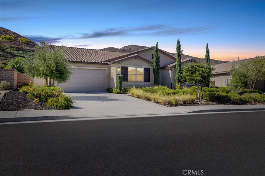 Welcome to Ponderosa Lane where dreams come true in this stunning 3100 sqft property sitting on almost a 14,000 sqft lot of land. The ranch style property features 4 bedrooms, 4 baths and a next-gen suite perfect for guests or income purposes. Located in the highly desirable gated community of Province in Audie Murphy Ranch, in Menifee, with mountain views, drought tolerant landscaping and nestled on the hillside with no rear neighbors. As you enter the home you are greeted by tall ceilings, recessed lighting, LVP floors, and a highly desirable floor plan. On the West wing of the ranch style property are two large secondary bedrooms both with walk-in closets, plush carpet, ceiling fans and tons of natural light flooding the space. The rooms share a secondary bath appointed with a dual vanity, quartz counters, and tub shower combo. Across the hall is a powder bath perfect for guests. Off the East wing of the home is the next-gen suite or Junior suite boasting a large room that can be split into a bedroom and living area or can be used as a large office or gym and offers a nook perfect for an exterior door to be built for private access. The bedroom has its own walk-in closet and attached bath featuring a single vanity and real tile walk-in shower. The amazing Great Room is appointed with large windows allowing tons of natural light to fill the entirety of the home, two ceiling fans and a massive space to decorate your dream living area. Off the Great Room is a large dining area that peers into the gourmet kitchen. The kitchen is appointed with granite counters, subway tile backsplash, stainless steel appliances, tons of storage with pull out drawers in the cabinets, and an eat up island. A flex space is the perfect office directly behind the kitchen and flows into a custom-built butler’s pantry and walk-in pantry. The large laundry room features a wash sink, the RO water filtration system and access to the 3-car tandem garage. The custom backyard boasts a $75,000 landscape design featuring an enclosed sun run patio cover with screens to allow airflow and doors to the rest of the yard which is appointed with pavers, and tons of fruit trees including Pomegranate, lemon, lime, grapefruit, avocado, and fig. The side yard is the perfect size for a pool! The community includes pools, spa, sports courts, club house, skate park, hiking and biking trails, and the award winning Taawila ES and new Kathryn Newport MS. Located between the 15 and 215 freeways!