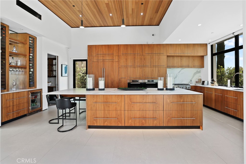 Welcome to a one-of-a-kind single-story architectural icon and nestled at the end of a private cul-de-sac on The Huntington Club Golf Course. Custom built over five years with masterful intention, this Zen-inspired, light-filled sanctuary blends timeless design with modern luxury across 4 bedrooms, 4.5 baths, a gym, and a 3-car garage plus a carport.
From 14-foot ceilings in the great room, expansive 30-foot sliding glass walls, and a central courtyard that invites natural light, peaceful water sounds, to golf course views into the heart of the home. Every inch of this residence was touched by artisans—from the hand-crafted walnut kitchen cabinets with continuous floor-to-ceiling grain, to the seamless integration of nature and architecture that turns every window into a framed work of art.
The home features a California room, two fireplaces, radiant floor heating with multi-zone control, and dual-zone HVAC for comfort, and Lutron smart lighting. The semi-private outdoor lounge—just off the second primary suite—wraps around a sculptural Japanese maple, perfect for quiet evenings or vibrant gatherings under the stars. Fully prewired for smart technology including TVs, ADT, Ring, and security cameras.
This is more than a home. It's a lifestyle. A statement. A forever sanctuary built with accessibility in mind—ideal for all life stages, including aging in place.