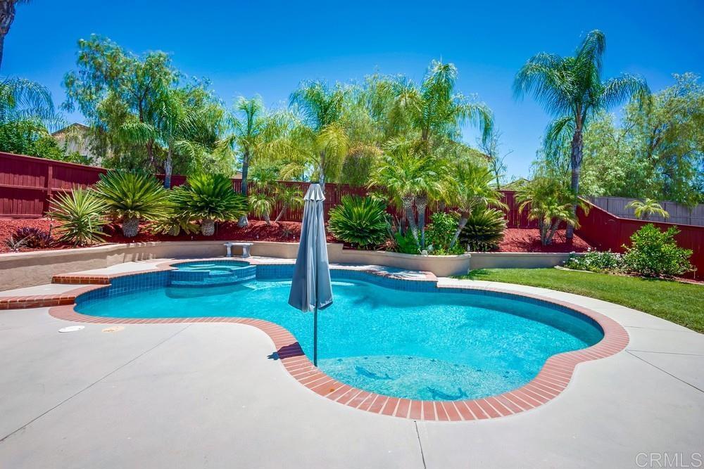 PRICE REDUCED! Welcome to this beautifully upgraded home nestled in the highly sought-after Carmel Hills Community in Wildomar. Offering 6 spacious bedrooms ,a full bedroom with bath downstairs as well as a versatile upstairs loft, you will have plenty of space for family, guests a home office set-up or multi-generational living. This residence offers a blend of comfort and functionality. Step inside to find wood-style tile plank flooring throughout the main level, elegant crown molding, and a cozy stone fireplace in the family room. The gourmet kitchen is a chef’s dream, featuring a large center island, granite countertops, custom tile backsplash, plenty of cabinetry, a pantry closet, and stainless steel appliances, including a newer range. Upstairs, you'll find oversized bedrooms perfect for relaxation, and enjoy year round comfort with Central A/C and Heat while a newer whole-house fan helps with energy-efficiency. An upstairs laundry room is an added convenience. French doors open to the primary bedroom with enough space for a king size bed and then some. Relax in your primary bathroom with a dual sink vanity, makeup table and a separate soaking tub. This also features a large walk-in closet. For the person who loves the to work on projects, the spacious 3-car garage comes equipped with new roll-up doors, industrial lighting and plenty of room to set up a work station with storage cabinets that offer both function and flair. Step outside to your own private resort-style backyard, fully landscaped with tropical plants, fruit trees, a grapevine and a custom solar-heated pool and spa with a tranquil waterfall feature and built in BBQ area, perfect for relaxing or entertaining family and friends. The oversized driveway offers extra parking—plenty of space for your guests. Other upgrades include a recently painted home exterior as well as the freshly painted wood fencing. Located in a quiet neighborhood, and convenient access to schools, shopping, and the 15 freeway. This is the kind of home where memories are made, don't miss your chance to make yours. ** Click on Virtual Tour Link to view home in 3D **