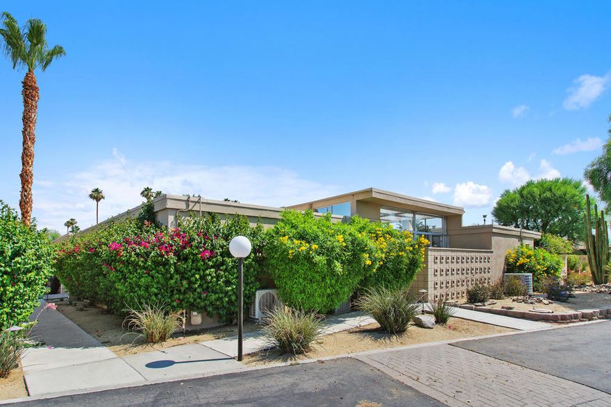 Welcome to the historic community of Tamarisk West.  If you sometimes wonder if you are living in your own Hollywood movie there's a good reason why.  S. Charles Lee, the architect of Tamarisk West 1 & 2, is considered America's preeminent movie theatre designer of the early 20th century.  His Art Deco and Modern-style period theatres number more than 400 including 250 in the Los Angeles area such as the Bruin Theatre in Westwood and the Tower Theatre in LA.  The desirability of homes in this community do not come on the market very often.  This updated 2Bd, 2.5BA Mid-Century Modern Home is very charming  and features Walls of Glass, Open Floor Plan, Spacious Walk-in Closets, Mountain Views, Polished Concrete & Tile Flooring, carpeted bedrooms, and a bright and airy Atrium.  Enter through double doors to the entry hall and open concept living room with tall ceilings featuring a wall of sliding glass doors highlighting the community pool and gardens which are steps away from inside the home or from your own relaxing outdoor patio.  Clerestory windows and vaulted ceilings with skylights in the Atrium create volume, lots of bright light, and additional living space to relax in while enjoying your beverage, reading your favorite book or entertaining guests. This home shares an enclosed garage, has its own golf cart garage, newer AC's, updated electrical panel and the roof was completely redone in May 2025. Conveniently located in the heart of Rancho Mirage, adjacent to the prestigious Tamarisk Country Club, near Eisenhower Medical Center, dining, shopping & entertainment and the El Paseo shopping and restaurant District.  This is a must see for desert architecture enthusiasts!
