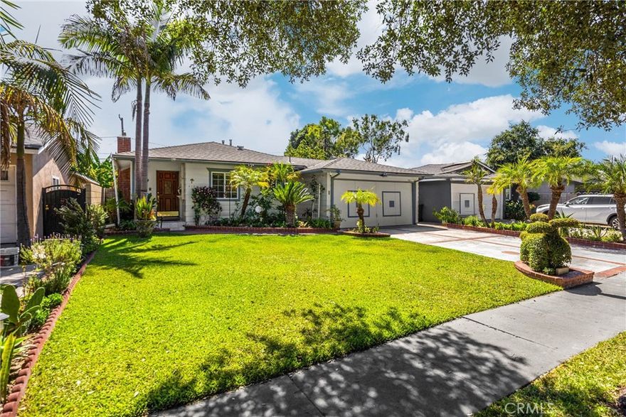 Charming Remodeled Home with ADU in the Heart of Santa Ana!  This beautifully updated property, offering the perfect blend of character, comfort, flexibility, and income potential, has been thoughtfully remodeled to feature a main residence and a fully equipped ADU (Accessory Dwelling Unit) under one roof, each with its own address and separate electrical meter, all all on a cul-de-sac in the vibrant center of Santa Ana! The main house boasts two spacious bedrooms plus a bonus expansive room, about 300 additional square feet, currently used as third bedroom, created by enclosing the patio and with direct access to the lush backyard. Inside the main home, you'll find gleaming oak hardwood floors, a warm and inviting dining room with gas fireplace, a cozy carpeted living room, and a remodeled kitchen complete with quartz countertops, farmhouse sink, glass-front cabinets, and a stainless steel range, a perfect blend of style and function. The ADU, located at 412 1/2 E Camile, offers its own private living experience, approximately 750 square feet (currently in the square footage), with a great room complete with a kitchen, living room, and dining area. Additionally, it has a bedroom and a remodeled bathroom, its own electric meter, furnace, and in-unit laundry. Currently accessible through both its own side entrance and the main house, it can easily be made entirely private with a simple wall closure. The ADU also enjoys its own fenced patio, offering privacy and a peaceful outdoor retreat. All this about the house, now to the amazingly lush backyard! Step outside into an oasis-like garden filled with colorful flowers, multiple patios, and a delightful variety of fruit trees—including lemon, strawberry-guava, orange, and apple. This enchanting outdoor space provides the perfect escape and a beautiful setting for entertaining guests. Centrally located, Downtown Santa Ana with its fabulous restaurants, events, and nightlife are just a few minutes away!  Whether you're looking for multi-generational living, rental income, or simply a home with extraordinary flexibility, this Santa Ana gem offers it all!