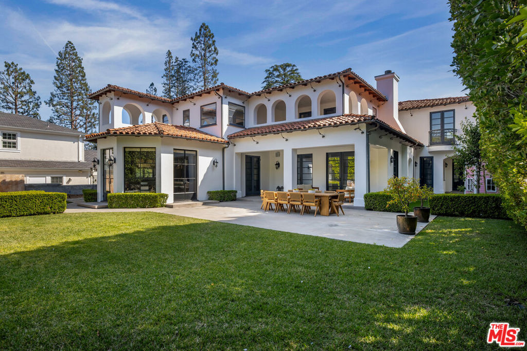Located on the coveted 700 block in the heart of Beverly Hills Flats, this elegant Mediterranean estate sits on an expansive 16,300+ sq.ft. lot. Behind its classic facade lies a thoughtfully designed home featuring soaring ceilings, a dramatic two-story foyer, and a sweeping staircase that sets a grand tone upon entry. The richly paneled living room boasts a stately fireplace and custom built-ins ideal for showcasing art or treasured books. A gracious formal dining room offers ample space for sophisticated entertaining, while the gourmet kitchen outfitted with premium appliances opens through striking steel-frame windows to lush rear gardens. Enjoy resort-style outdoor living with a generous grassy lawn, sparkling pool, and a separate guest house for added flexibility. The upper level hosts five spacious bedrooms, including a luxurious primary suite retreat. Additional highlights include a main-level staff suite and direct-access two-car garage. A rare opportunity to own an exceptional property just moments from the finest dining, shopping, and cultural attractions Beverly Hills has to offer.
