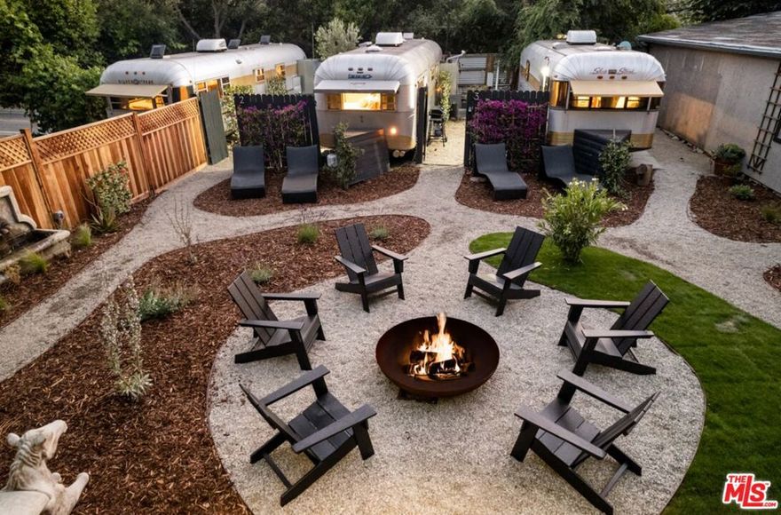 Boho Chic Airstream Retreat in Topanga Canyon: Discover a unique blend of style, comfort, and nature in this modernized Streamline Airstream-inspired home, tucked away in the heart of beautiful Topanga Canyon. Offering approximately 7,000 square feet of living space, this two-bedroom, two-bathroom property delivers a one-of-a-kind lifestyle that balances rustic charm with contemporary convenience. Step inside to find thoughtfully designed interiors featuring a light-filled living area, a functional kitchenette, and 2 bathrooms with comfortable showers. The open layout creates a cozy yet airy atmosphere, perfect for relaxing after a day spent exploring. Open your door to a private yard surrounded by mature trees and greenery. Enjoy morning coffee or evening sunsets from your outdoor lounge chairs, with enough space for entertaining or simply unwinding in peace.Located just around the corner from Topanga State Park, you'll have direct access to endless hiking trails, canyon views, and natural beauty. A short drive takes you to the Topanga surf break, local beaches, and the Pacific Ocean, making this an ideal retreat for outdoor enthusiasts and ocean lovers alike. For everyday conveniences, dining, and entertainment, Topanga Village is just a stone's throw away, offering restaurants, boutique shopping, and community gathering spaces. This property is part of a quiet enclave of just five residences four classic aluminum trailers (Spartan, Streamline, Silver Streak) and a tiny home each well-spaced to maximize privacy and tranquility. The intimate community setting allows you to enjoy a true canyon escape, while still being close to the amenities of the Westside and San Fernando Valley. With its distinctive design, peaceful surroundings, and unbeatable location, this Boho Chic Airstream retreat is more than just a rental it's an experience. Perfect for those seeking a unique Topanga lifestyle with easy access to both city and sea.