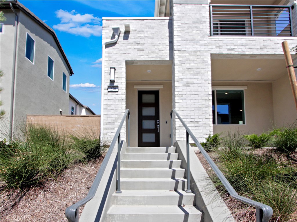 City vibes in this newly built, never lived in, 2-story detached 4-bedroom home with a private yard. Set on an elevated lot with a striking white brick façade, this home makes a stylish first impression. The grand staircase entry leads to a welcoming front porch, creating a sense of arrival and a distinctive city-living vibe. Unlike homes that face the street, this one faces inward toward a walking path, offering a more intimate, tucked-away setting. No cars park directly in front of the home making it ideal for those who like an upscale urban feel without the visual clutter of curbside parking. Inside, the open-concept first floor seamlessly blends kitchen, dining, and living areas — perfect for entertaining or simply enjoying everyday flow. The gourmet kitchen features modern stainless appliances and white quartz countertops and white shaker cabinets, plenty of counter space, and a large island that doubles as a breakfast bar. Upstairs, you’ll find four generously sized bedrooms, including a luxurious owner’s suite with a walk-in closet and spa-like bathroom complete with dual vanities and a shower with a built-in bench. The Primary suite has a private deck through sliding glass doors to enjoy your morning coffee or evening glass of wine. This home has epoxy floors in the garage, Electric Hunter Douglas blinds in the kitchen, Upgraded LVP flooring, Ring Doorbell, MyQ smart garage opener to remotely operate the garage, Tesla Powerwall + leased solar ($145/month, buyer to assume and verify with Sunnova) This home is also walking distance to Luna Park, currently under construction. The elevated porch and private pathway entrance add to the charm and uniqueness of this modern farmhouse retreat. The outdoor living space has plans that are approved by the HOA. Other highlights include a convenient upstairs laundry room with built-in shaker cabinetry, energy-efficient finishes, and a spacious two-bay garage with storage. This home is a rare blend of modern design, thoughtful upgrades, and a peaceful setting — the best of both comfort and convenience.
