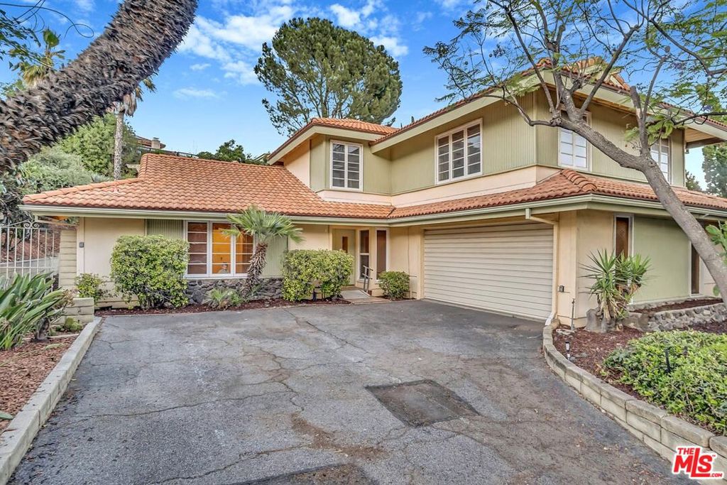 Looking for a smart investment in a sought-after Porter Ranch neighborhood? This 4-bedroom, 3-bath, 2-story gem offers versatility and privacy all wrapped into one compelling opportunity! Shaded by mature greenery, the double-door entry welcomes you into a warm and inviting interior where a stacked stone fireplace anchors the generous living room, ready for movie marathons or quiet evenings in. A wood-accented family corner ideal for entertaining stands just off the kitchen, where rich cabinetry, gleaming countertops, and a pendant-lit breakfast bar create the perfect setup for serving guests or enjoying morning coffee. Your striking primary suite is a retreat of its own with an oversized vanity in the ensuite, a walk-in closet, and ample natural light. Outside, a covered patio encourages weekend gatherings, while the fenced pool and sloped garden area present a creative canvas for leisure. Complete with a laundry nook and attached 2-car garage, your residence is located minutes from CSU Northridge, CA-118, Northridge Fashion Center, parks, and scenic hiking trails. Your next chapter could unfold here!