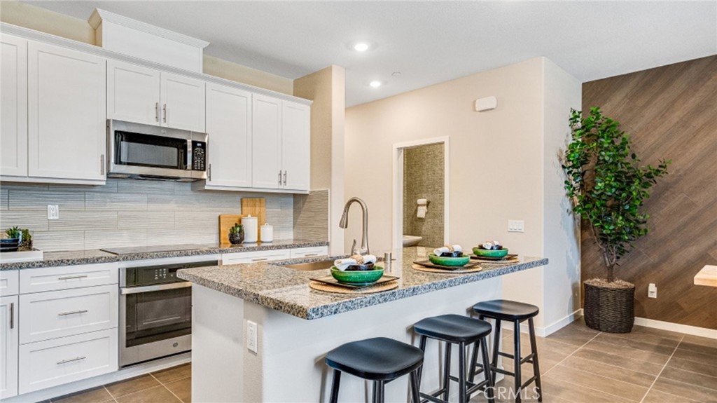 NEW CONSTRUCTION! This two-story home features a modern open floorplan on the first level, consisting of a relaxing Great Room, elegant dining room and fully-equipped kitchen with miami venna white quartz counters and gray cabinetry. Upstairs there are three bedrooms, including the luxurious owner’s suite, which is nestled into a corner of the home for enhanced privacy.
Copper Leaf is a collection of new condos for sale, coming soon to the Falloncrest master-planned community in Ontario, CA. Enjoy a multitude of onsite amenities, such as a social clubhouse, sparkling swimming pool, parks, picnic areas and a tot lot for the little ones to enjoy. A variety of shopping options are within close reach at Ontario Mills and Victoria Gardens. Or, enjoy some leisure at local spots such as San Antonio Winery or El Prado Golf Course.